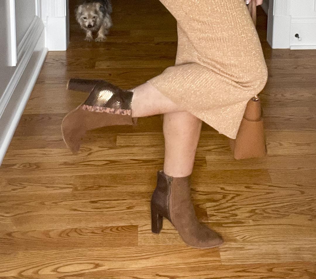 Over 40 Fashion Blogger, Tania Stephens is wearing a gold metallic sweater skirt and metallic ankle boots
