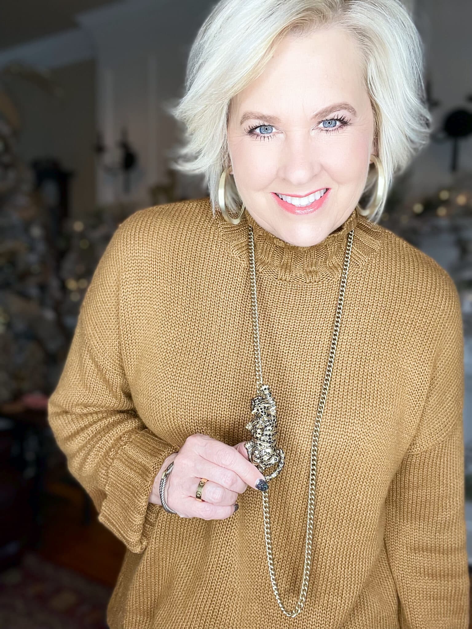 Over 40 Fashion Blogger, Tania Stephens is wearing a leopard necklace and a camel sweater