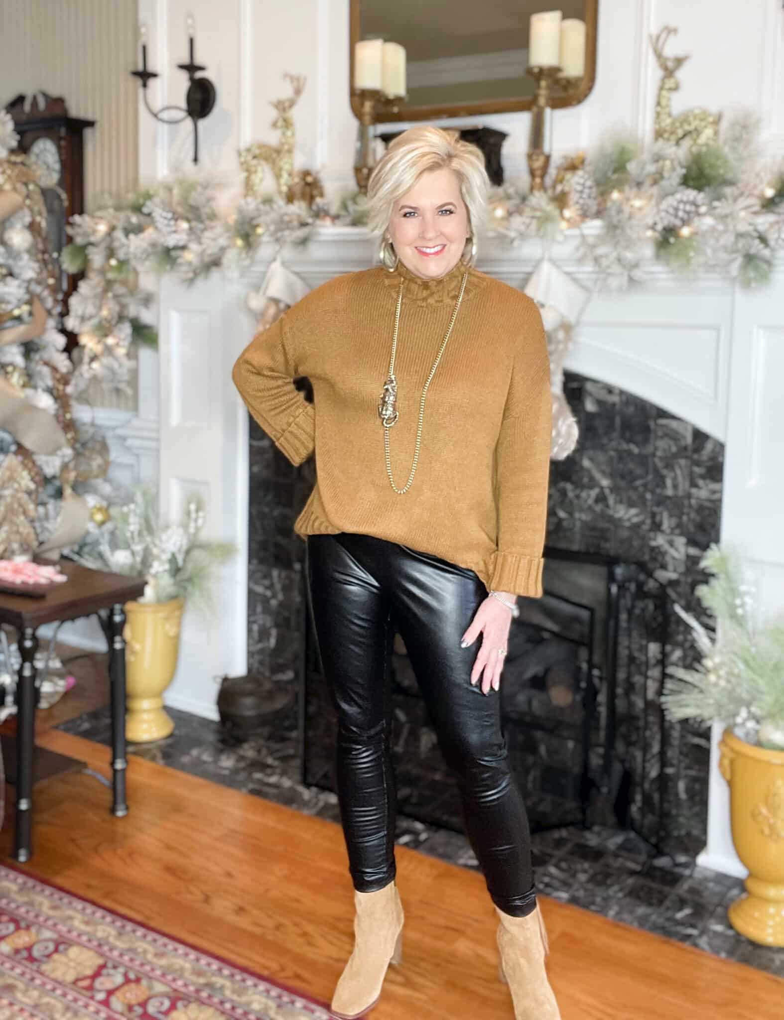 Over 40 Fashion Blogger, Tania Stephens is wearing A pair of faux leather leggings, a camel sweater, a leopard necklace, and ankle boots
