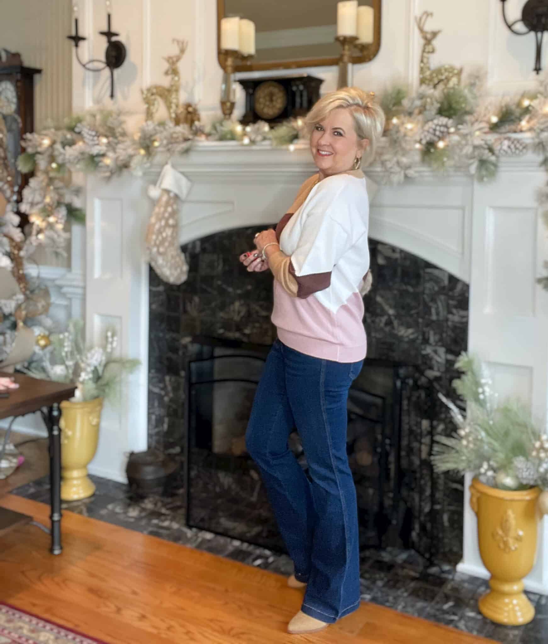 Over 40 Fashion Blogger, Tania Stephens is wearing a colorblock sweater from Amazon with Spanx jeans