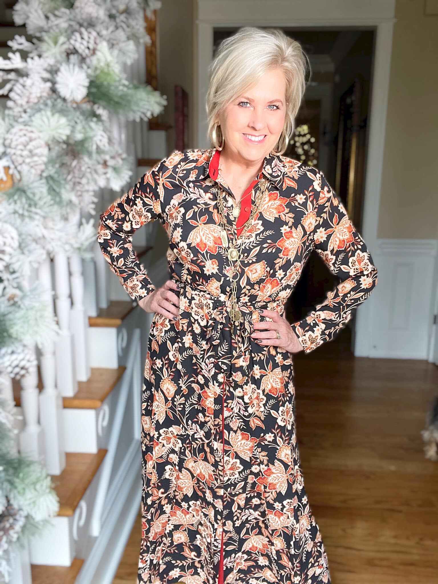 Over 40 Fashion Blogger, Tania Stephens is wearing a floral dress and gold jewelry
