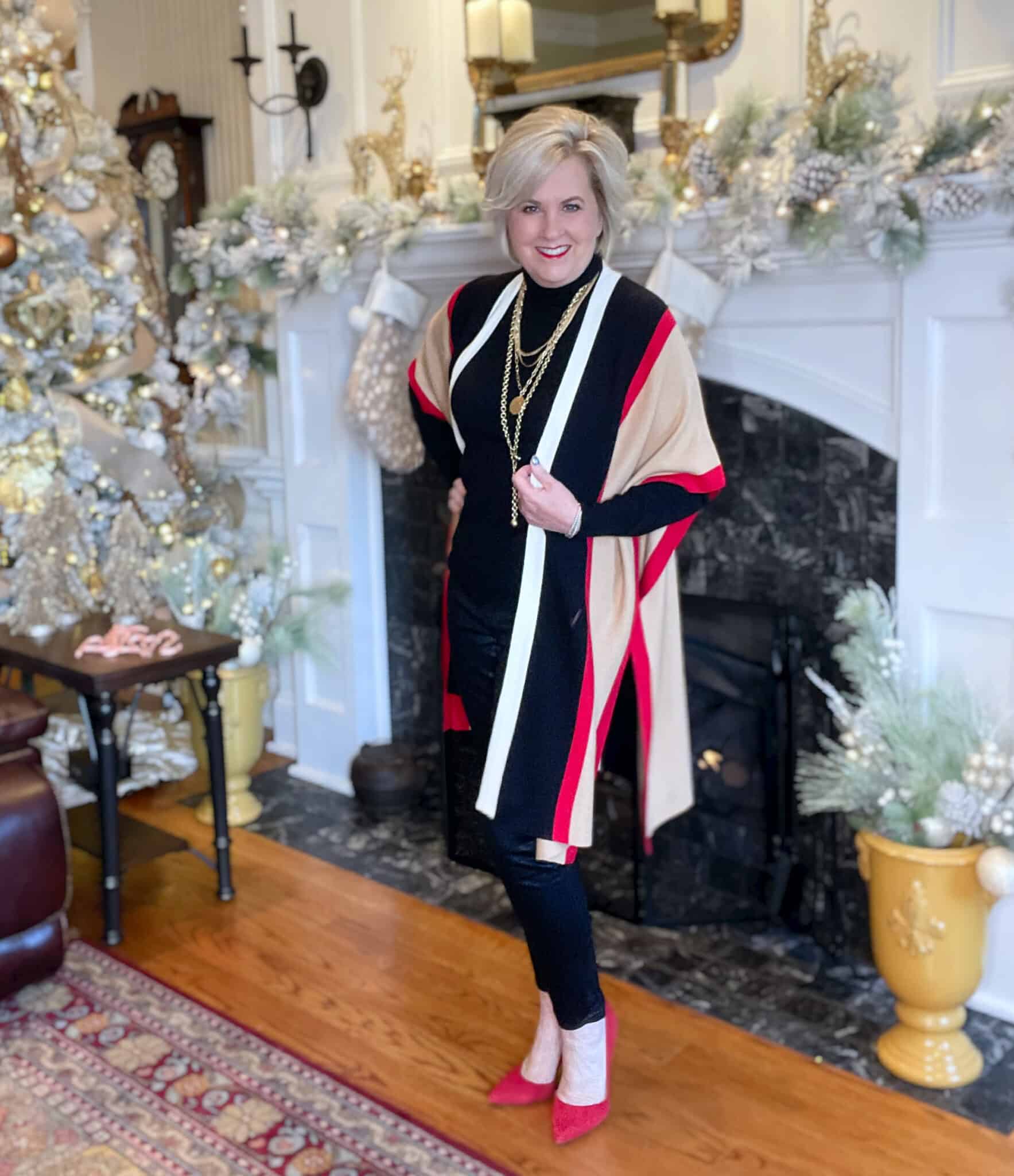 Over 40 Fashion Blogger, Tania Stephens is wearing a black turtleneck with a striped colorblock Ruana