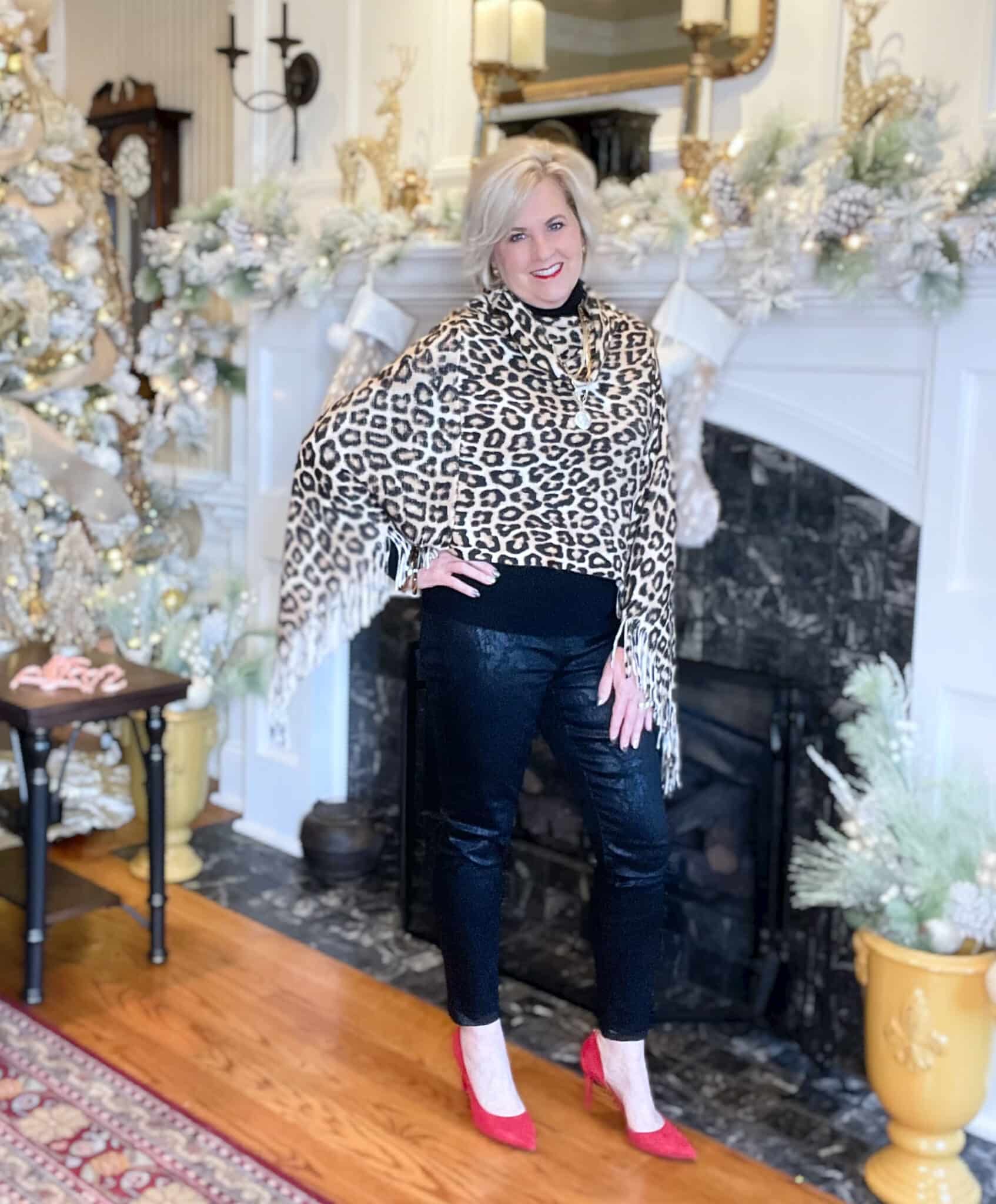 Over 40 Fashion Blogger, Tania Stephens is wearing an animal print fringe poncho with snakeskin pants and red pumps
