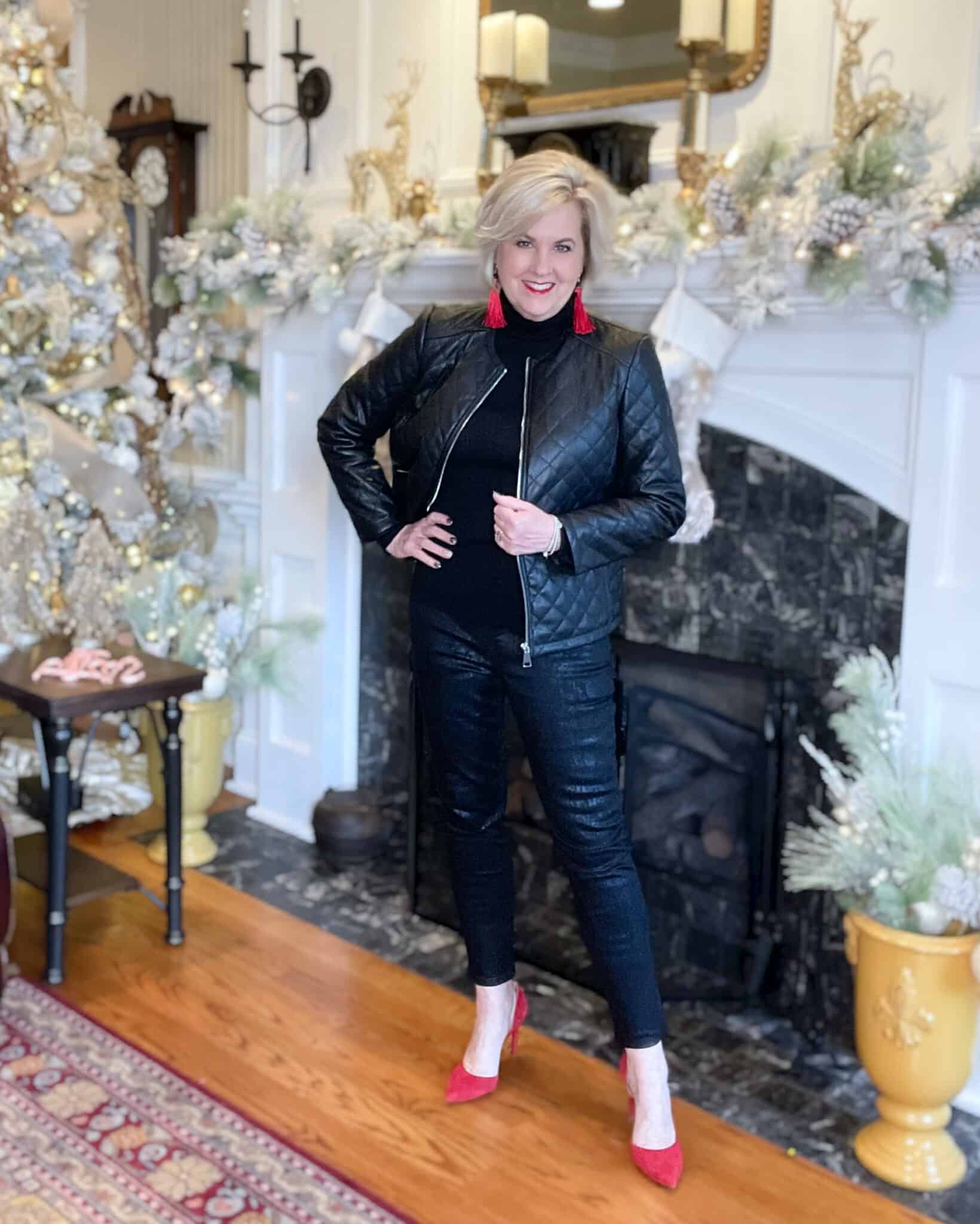 Over 40 Fashion Blogger, Tania Stephens is wearing a black outfit with bright red earrings and red pumps