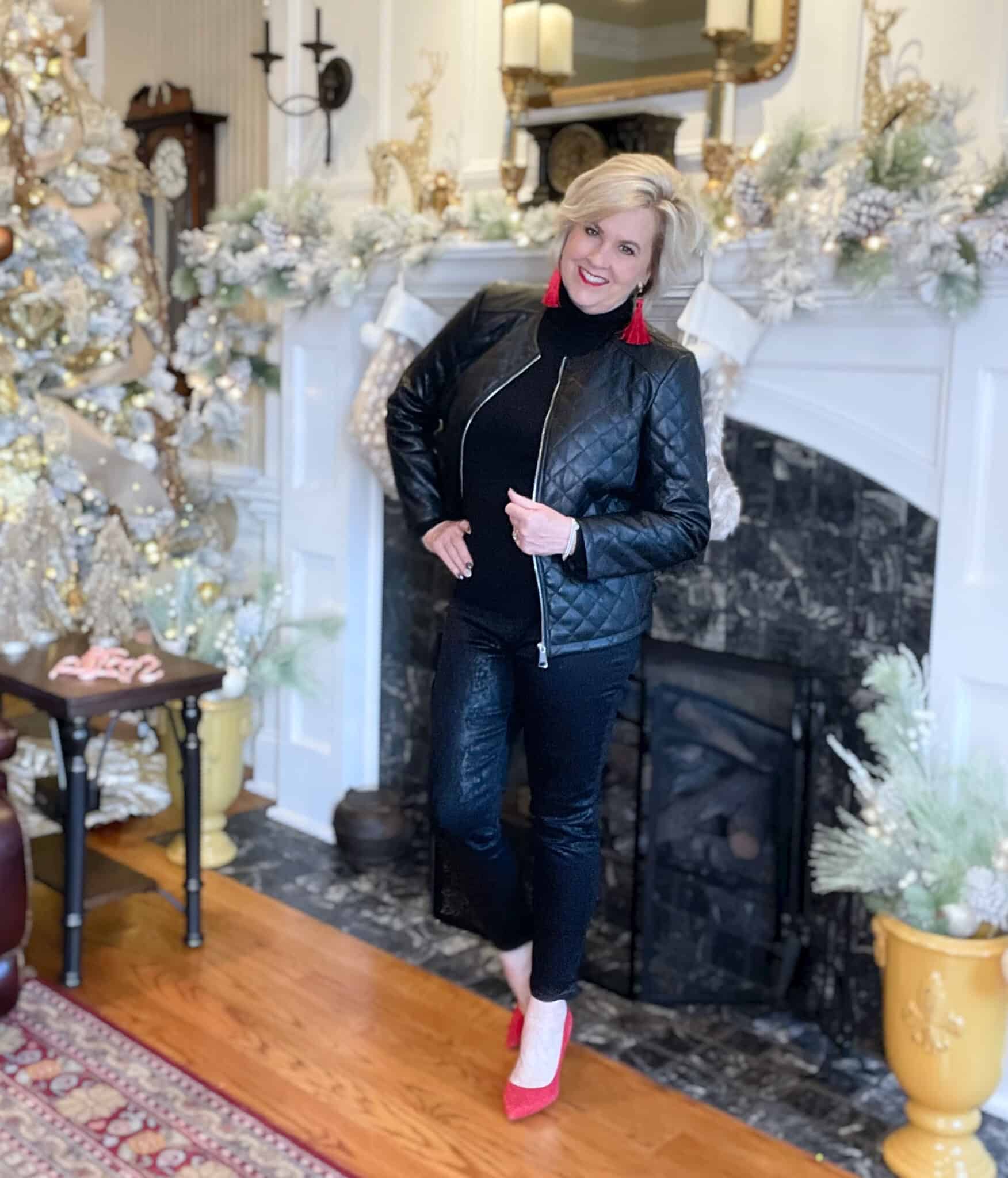 Over 40 Fashion Blogger, Tania Stephens is wearing a black outfit with red tassel earrings and red suede pumps