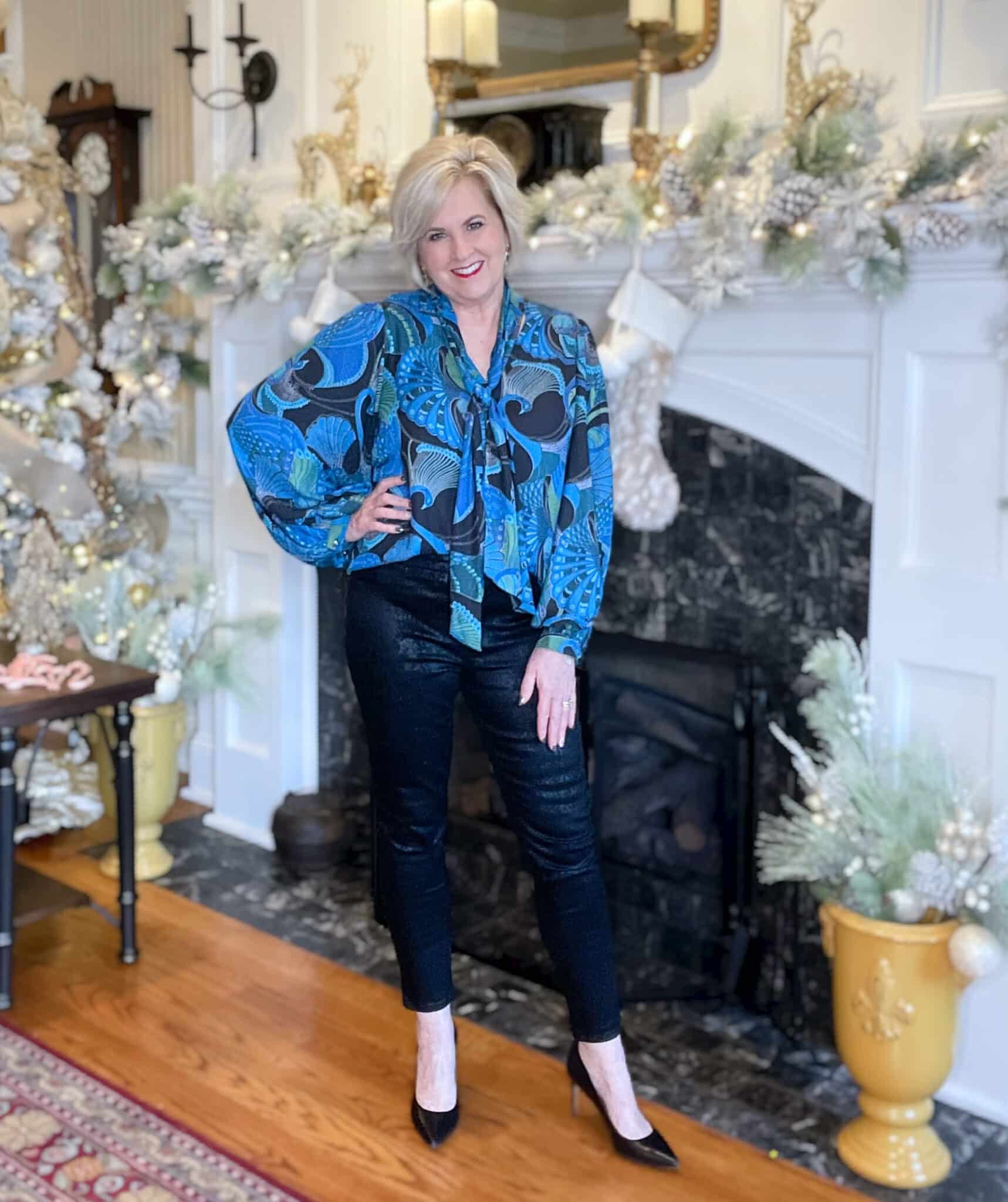 Over 40 Fashion Blogger, Tania Stephens is wearing a bright peacock satin blouse with snakeskin print jeggings
