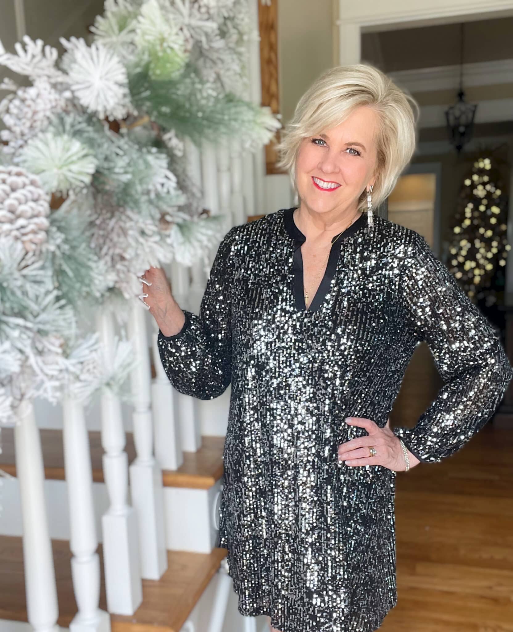 Over 40 Fashion Blogger, Tania Stephens is wearing a black sequined dress with silver earrings for New Year's Eve