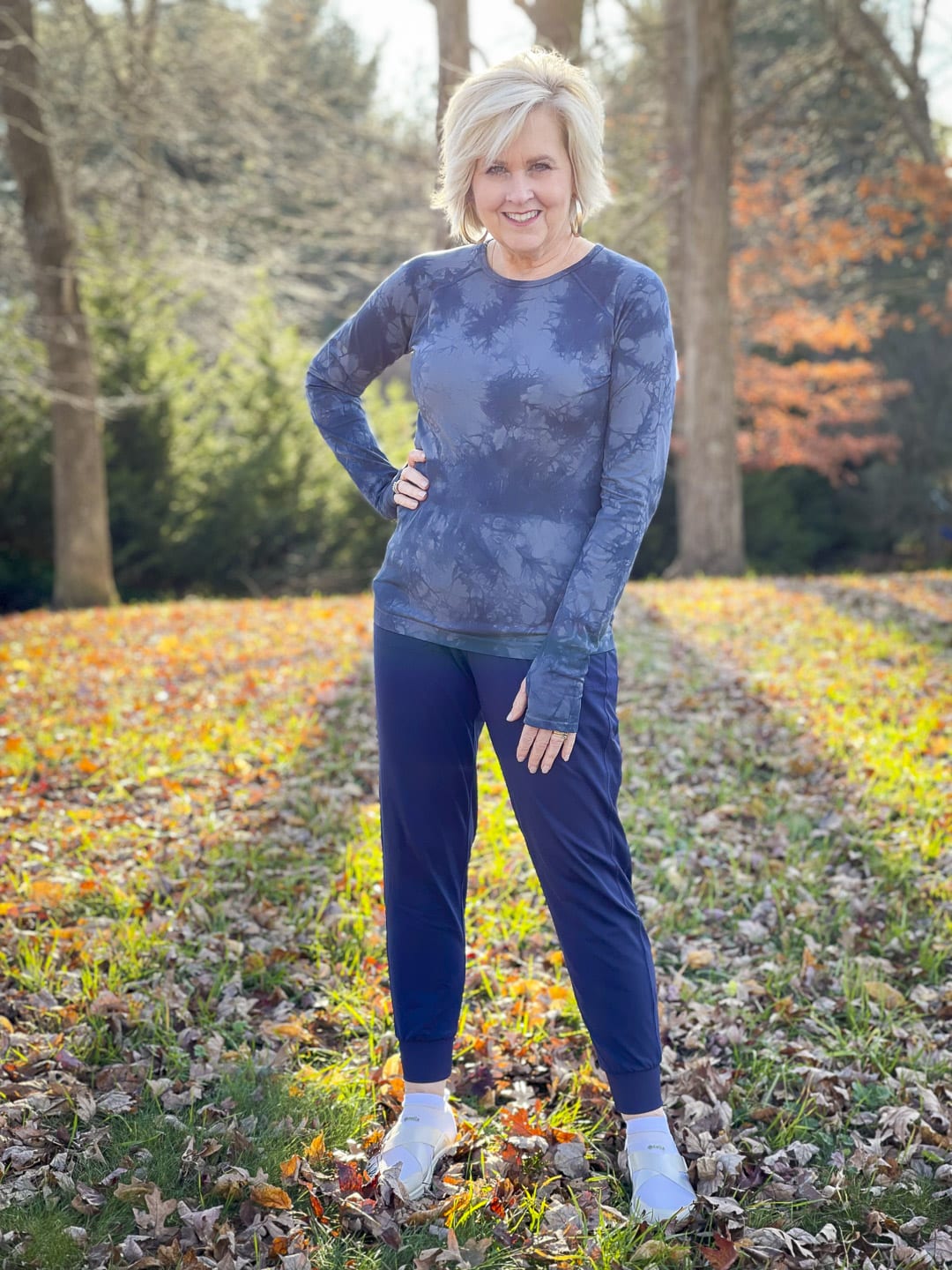 Over 40 Fashion Blogger, Tania Stephens is walking in the woods in activewear by Zella
