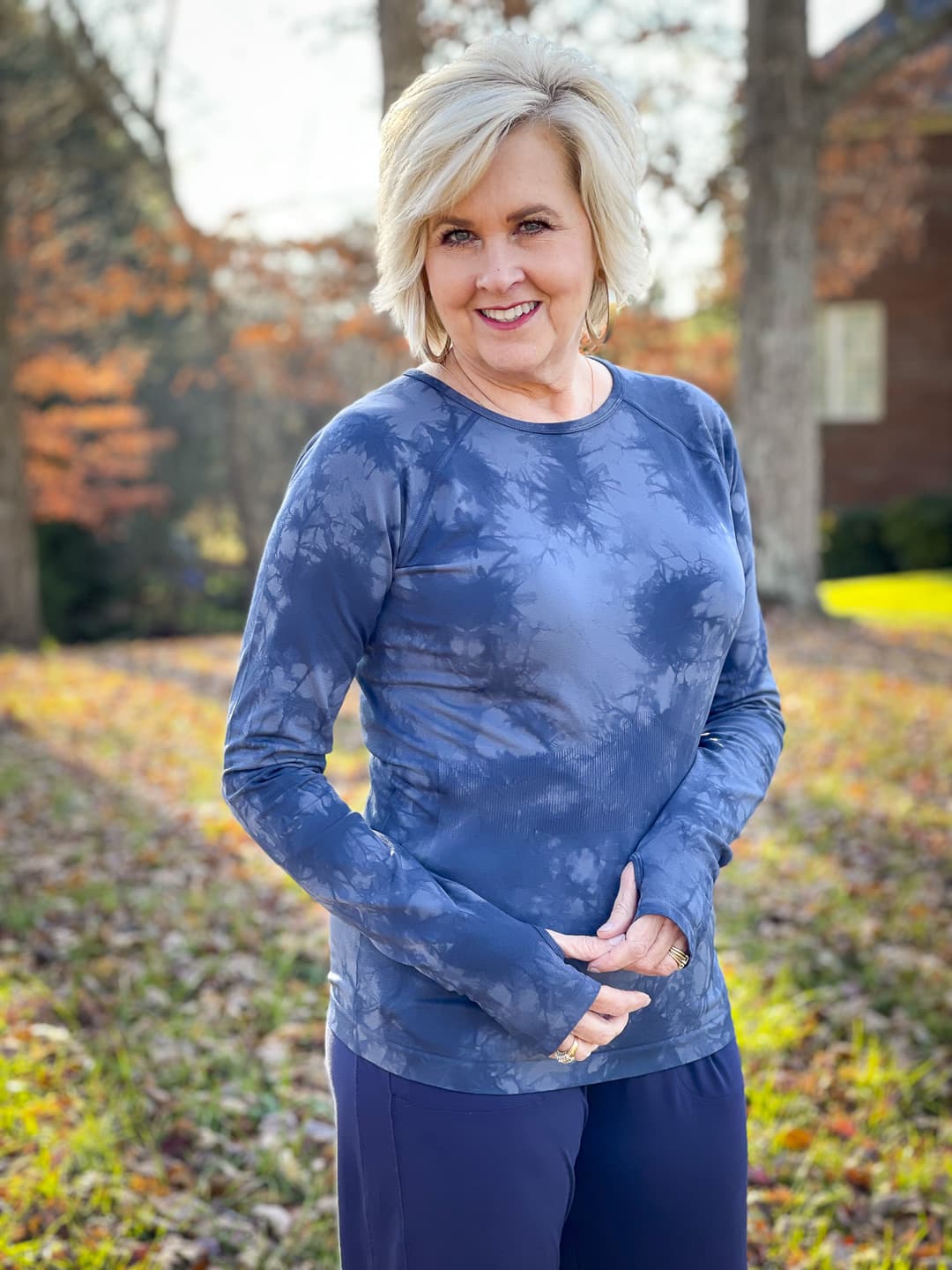 Over 40 Fashion Blogger, Tania Stephens is out for a walk in the woods in navy activewear