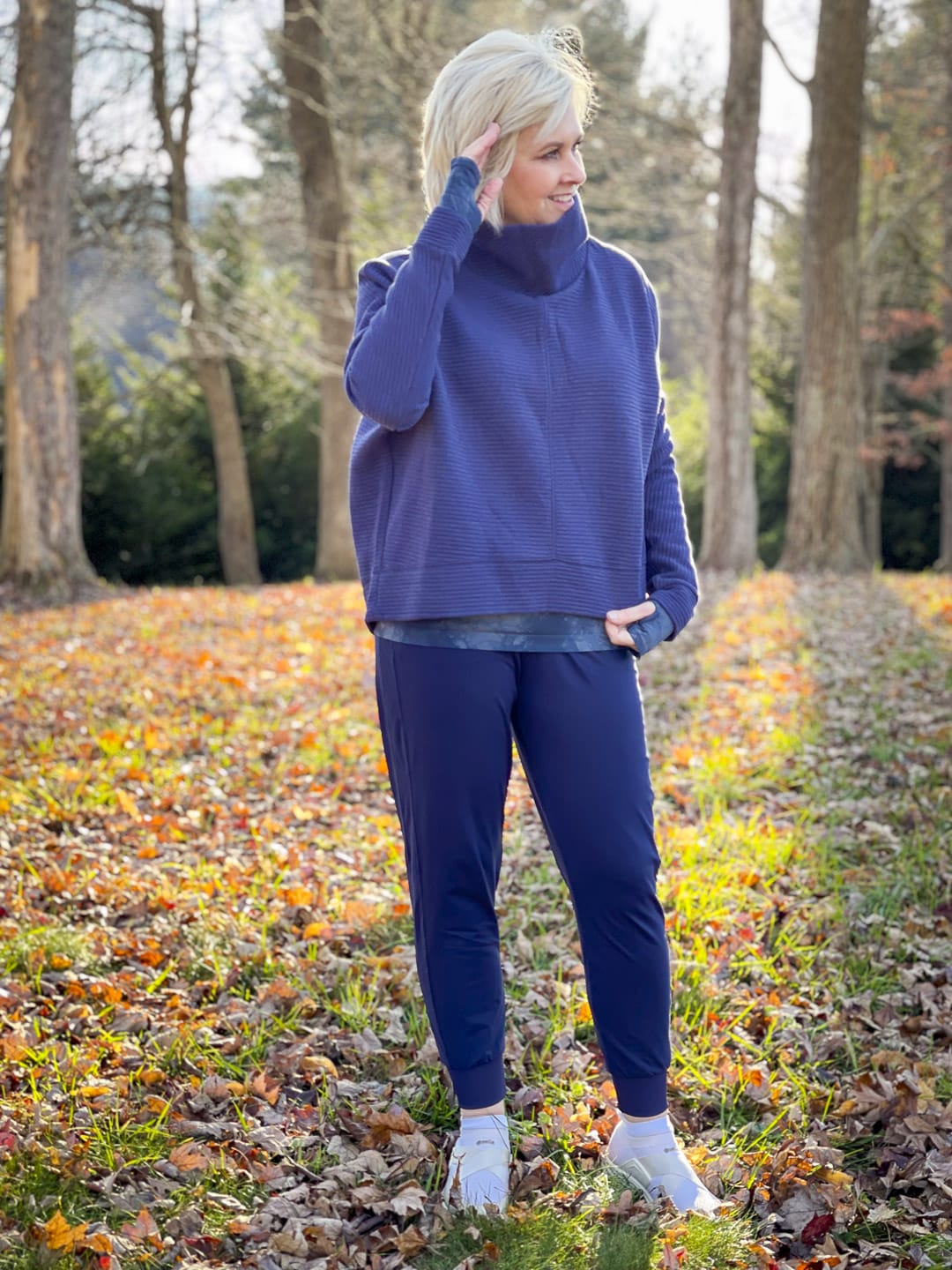 Over 40 Fashion Blogger, Tania Stephens is walking in the woods in Zella activewear from Nordstrom