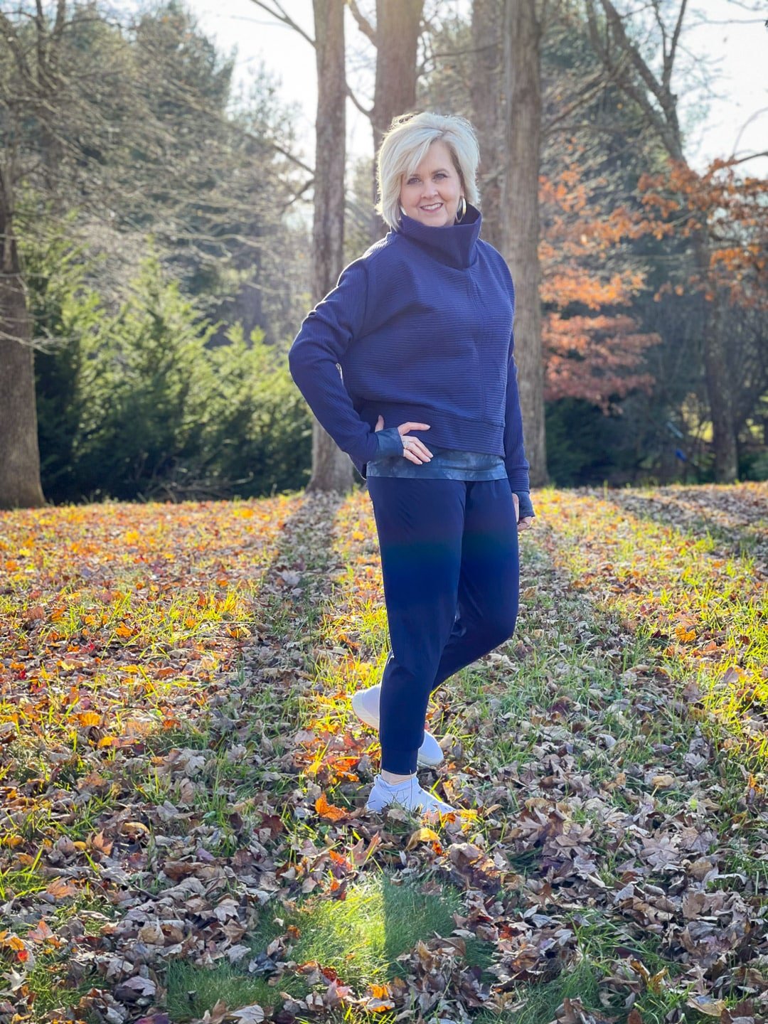 Over 40 Fashion Blogger, Tania Stephens is walking in the woods in Zella activewear