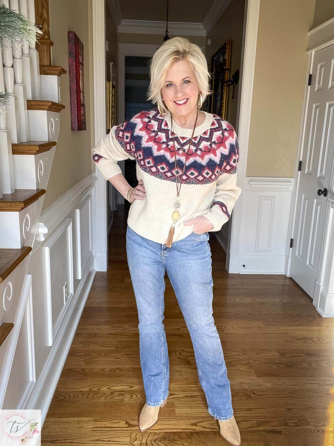 Over 40 Fashion Blogger, Tania Stephens is wearing a sweater and jeans look with pointy toe boots