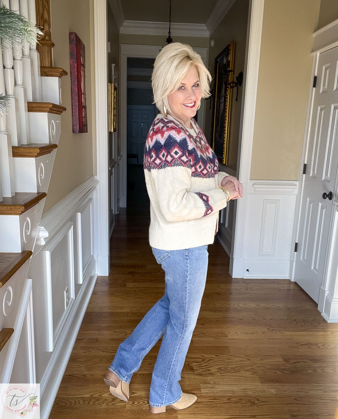 Over 40 Fashion Blogger, Tania Stephens is wearing a sweater and jeans look with gold jewelry