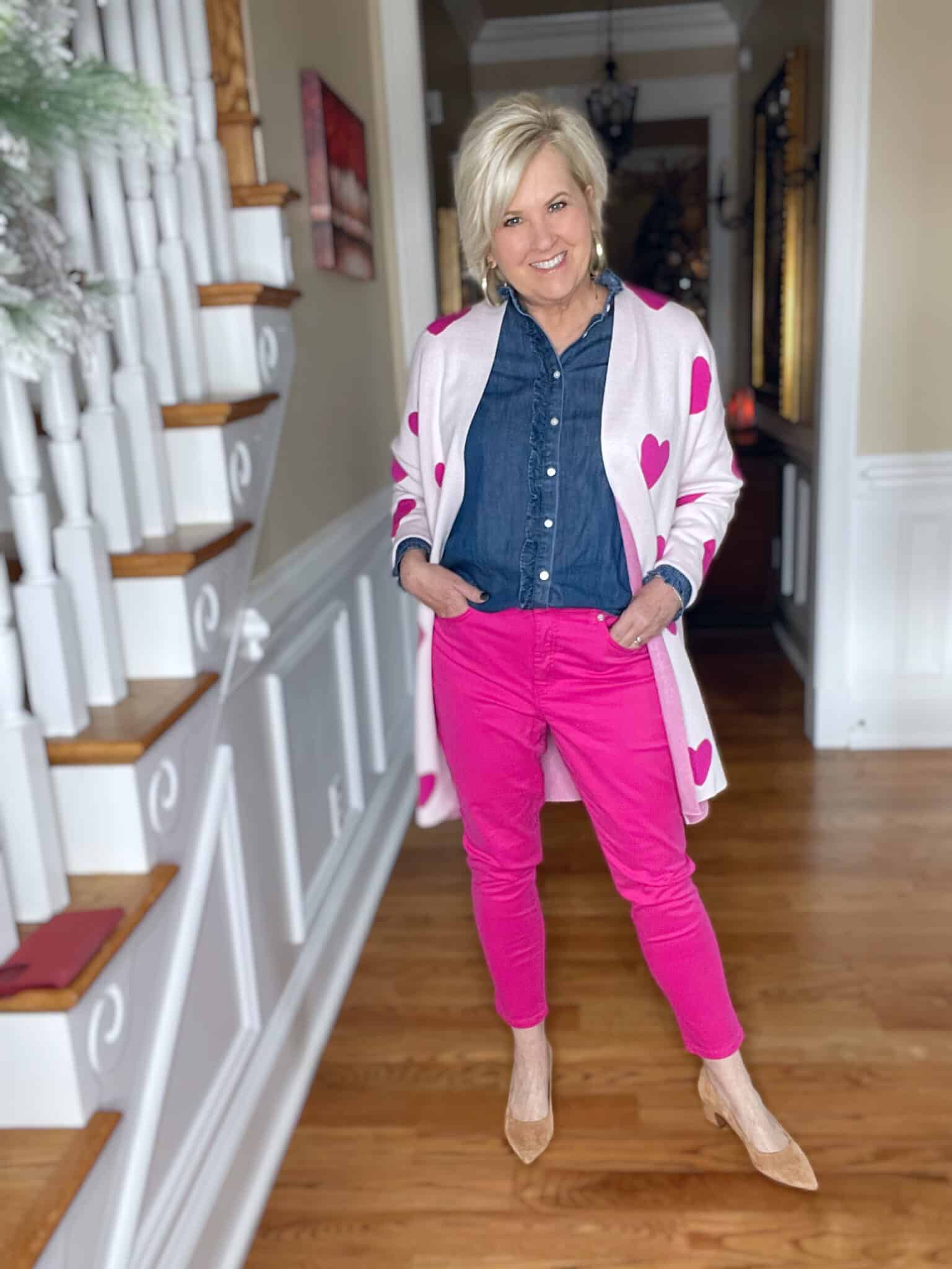 Over 40 Fashion Blogger, Tania Stephens is looking for love with her Valentine's Day hearts cardigan, ruffled chambray shirt, and pink jeans