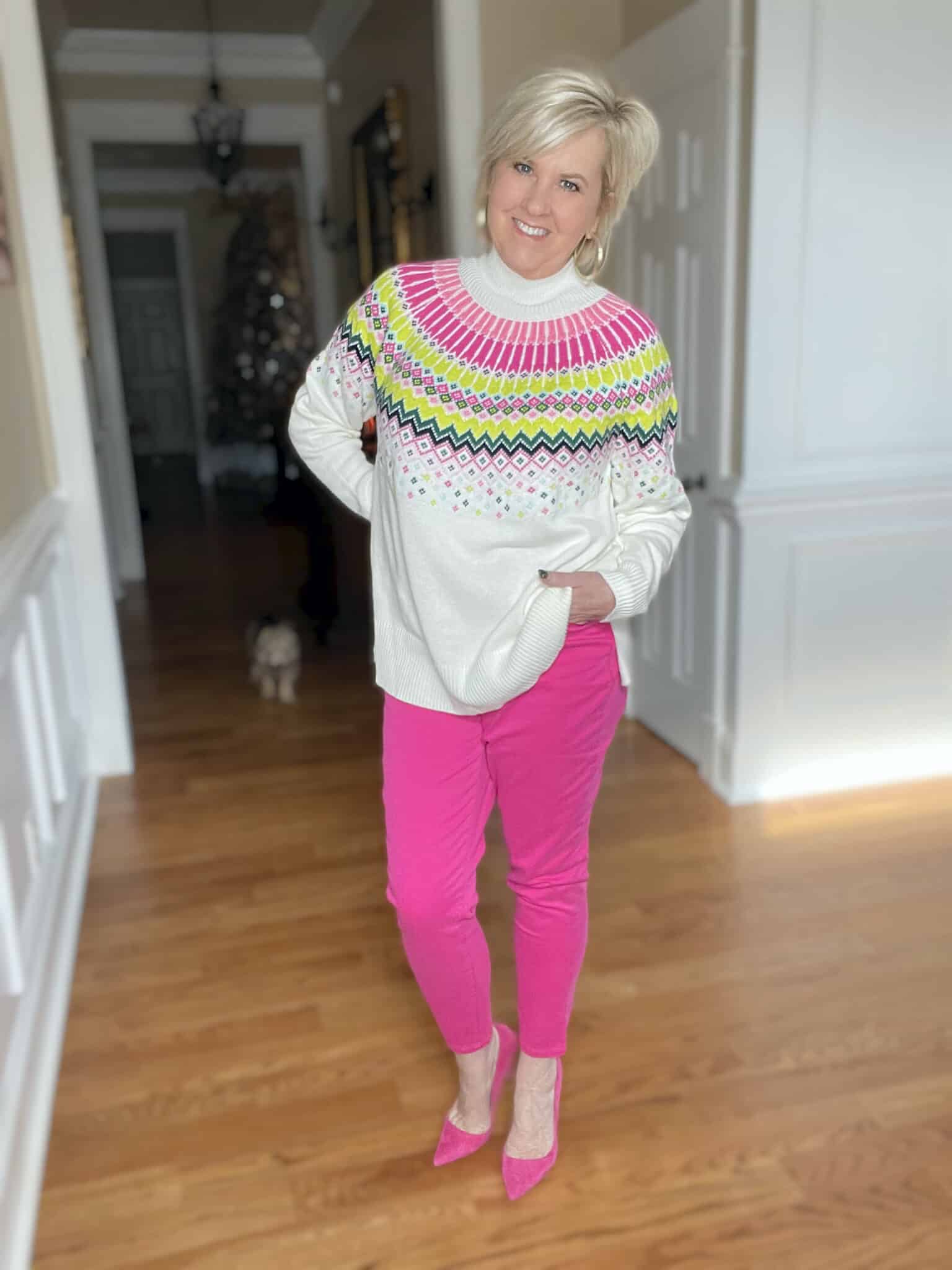 Over 40 Fashion Blogger, Tania Stephens is wearing bright pink jeans and a pink Fairisle sweater from Belk