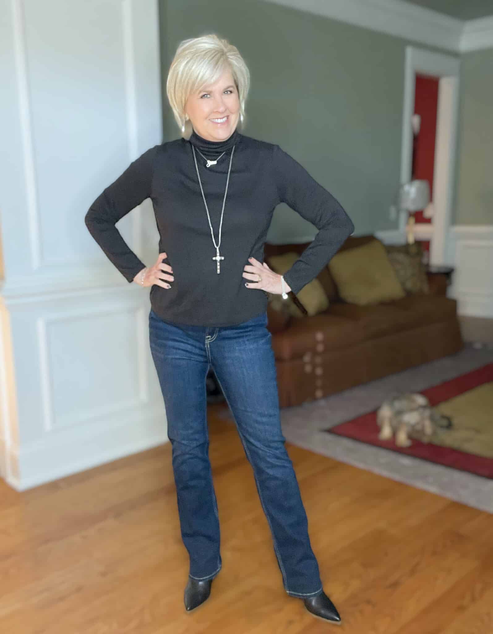 Over 40 Fashion Blogger, Tania Stephens is wearing a black turtleneck and jeans from Walmart
