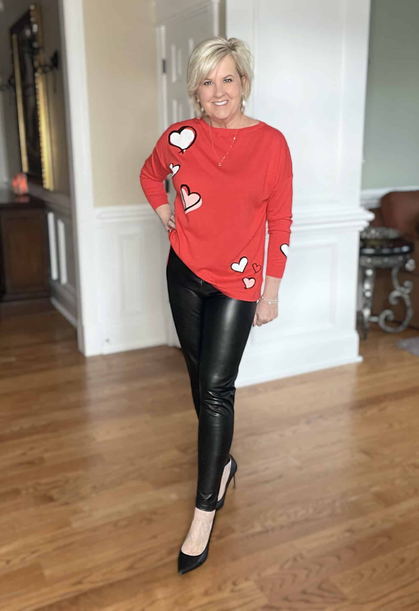 Over 40 Fashion Blogger, Tania Stephens is ready for Valentine's Day with this red floating heart sweater and black faux leather leggings