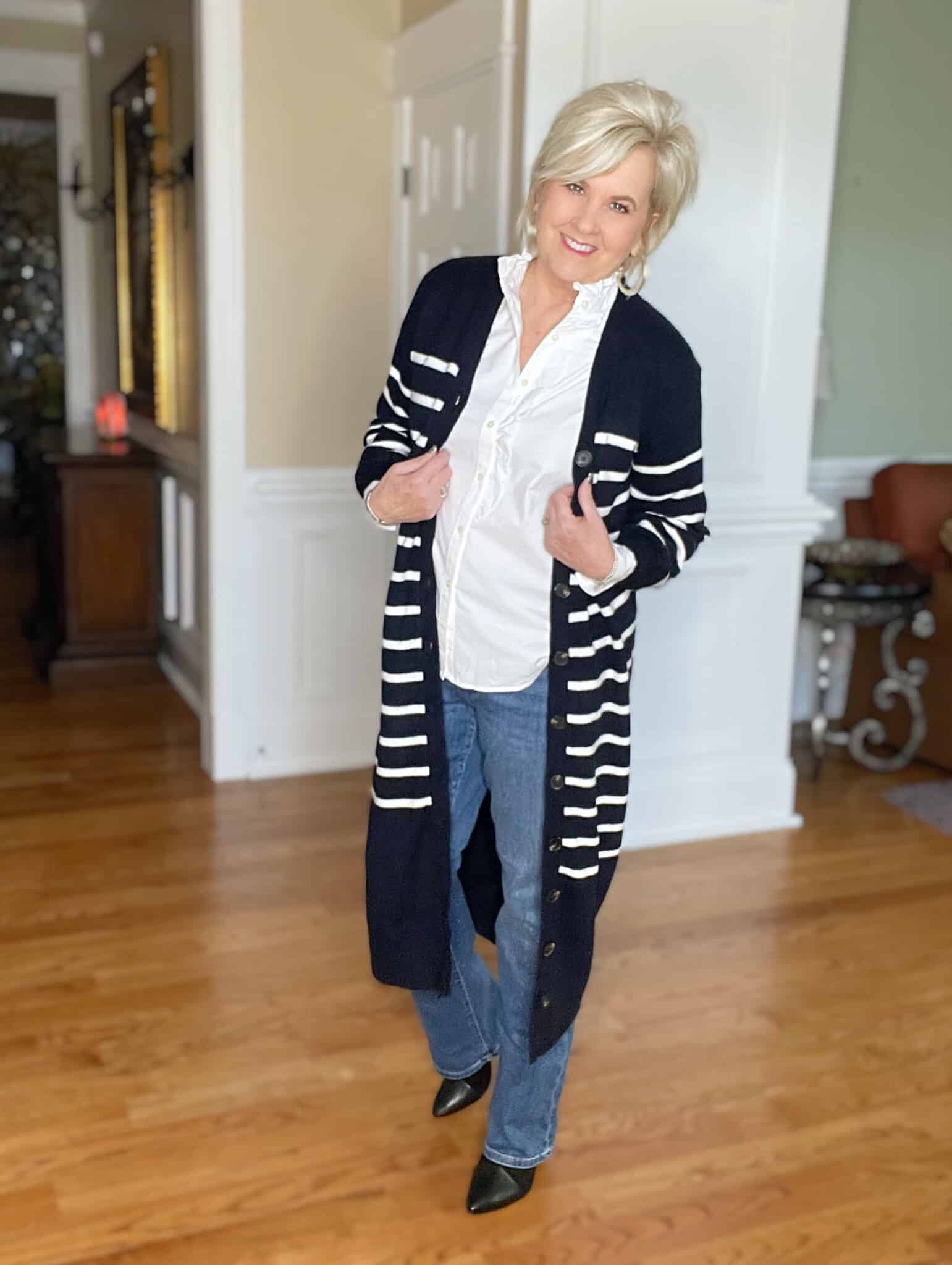 Over 40 Fashion Blogger, Tania Stephens is wearing a long navy and white cardigan with a white button up shirt and jeans