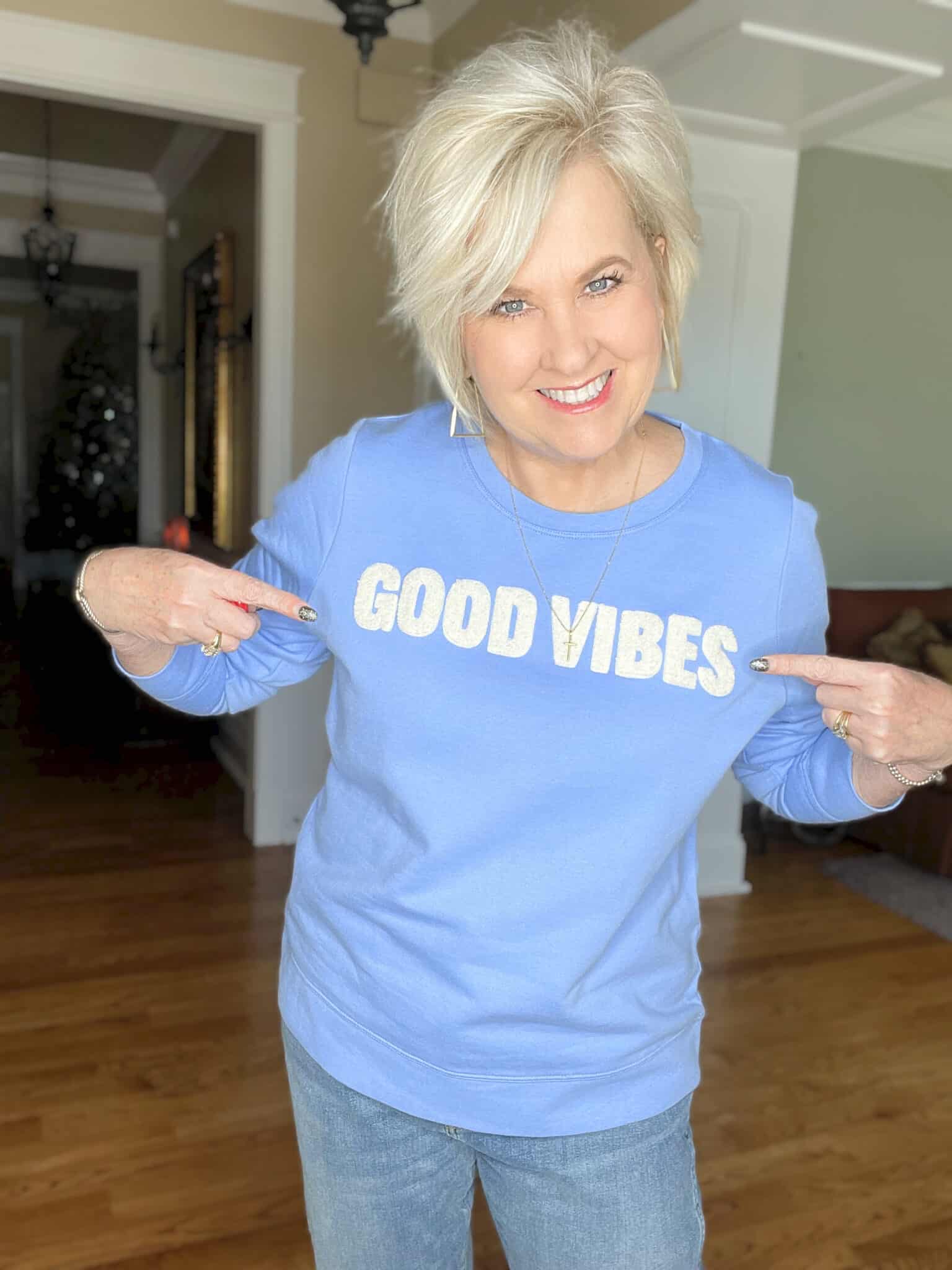 Over 40 Fashion Blogger, Tania Stephens is cozy in this blue Good Vibes sweatshirt from Loft