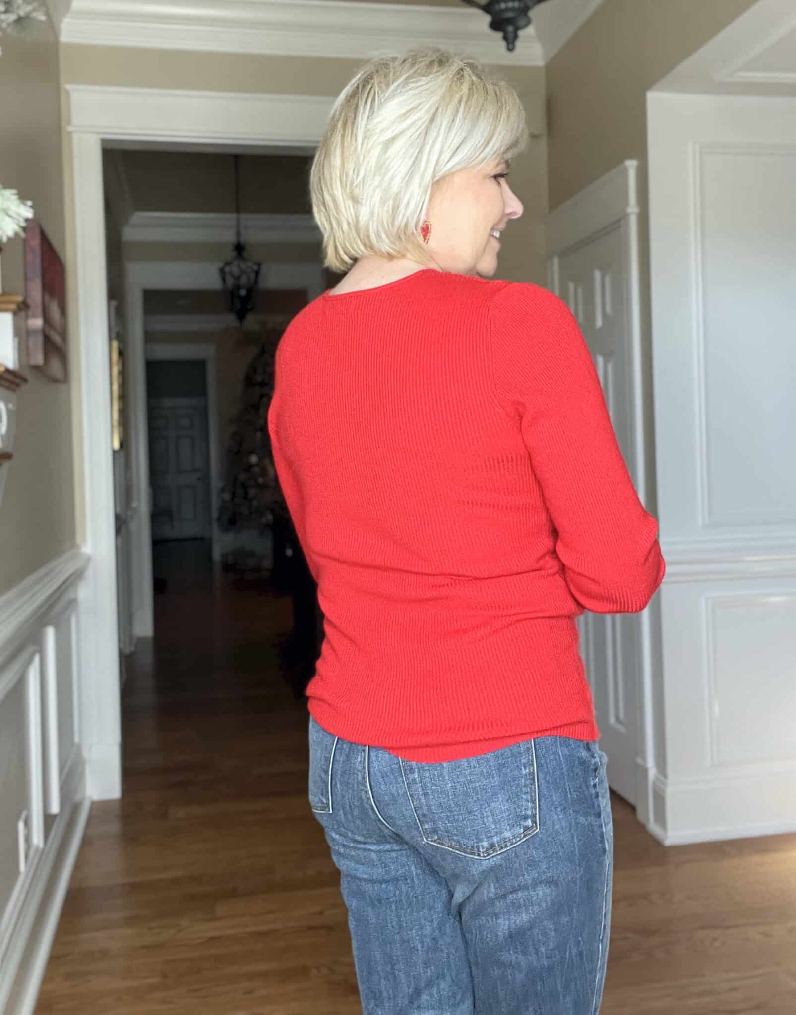 Over 40 Fashion Blogger, Tania Stephens is showing the back of a bright red sweater