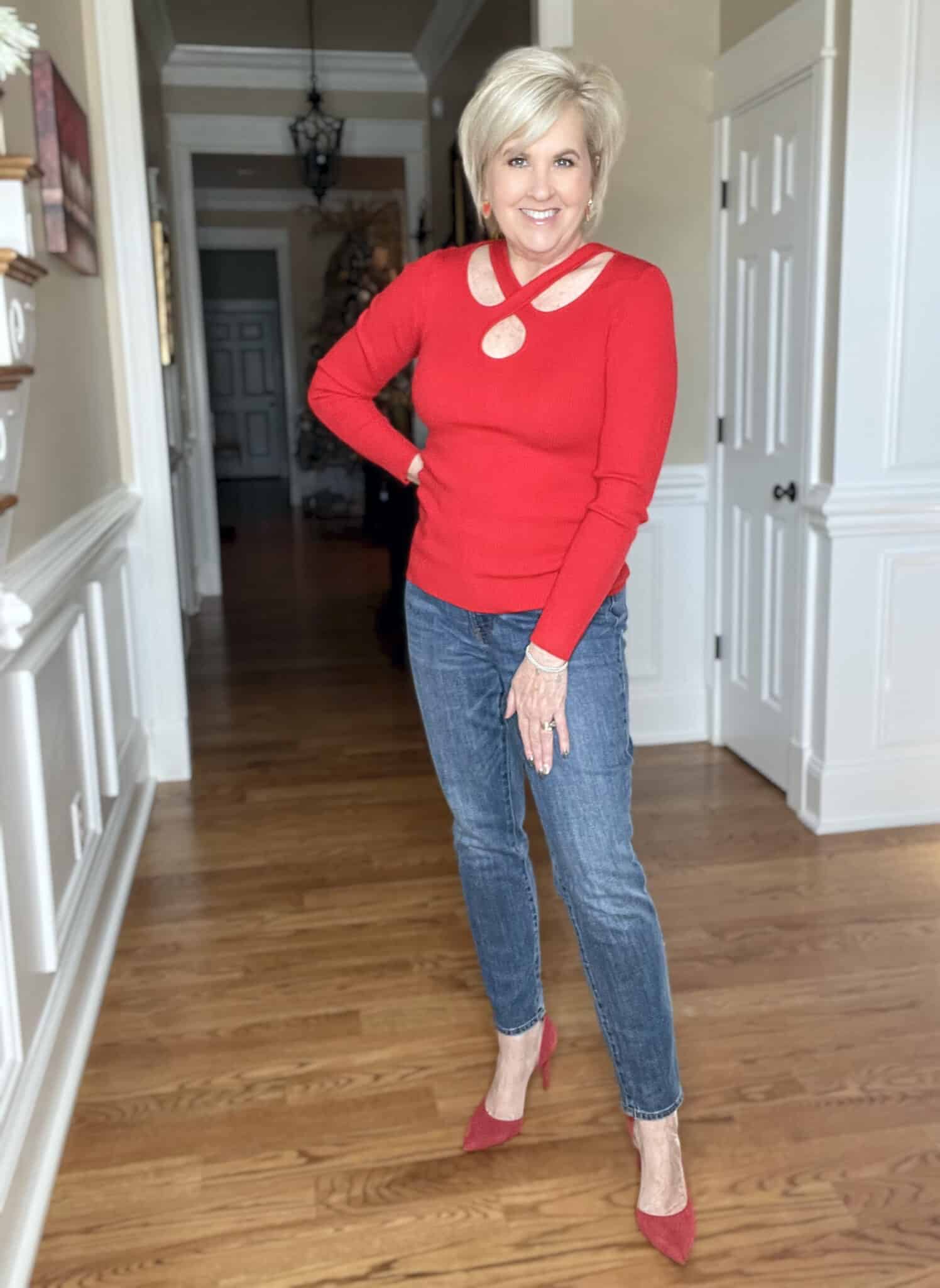 Over 40 Fashion Blogger, Tania Stephens is wearing a red sweater from Walmart, jeans, and red heels