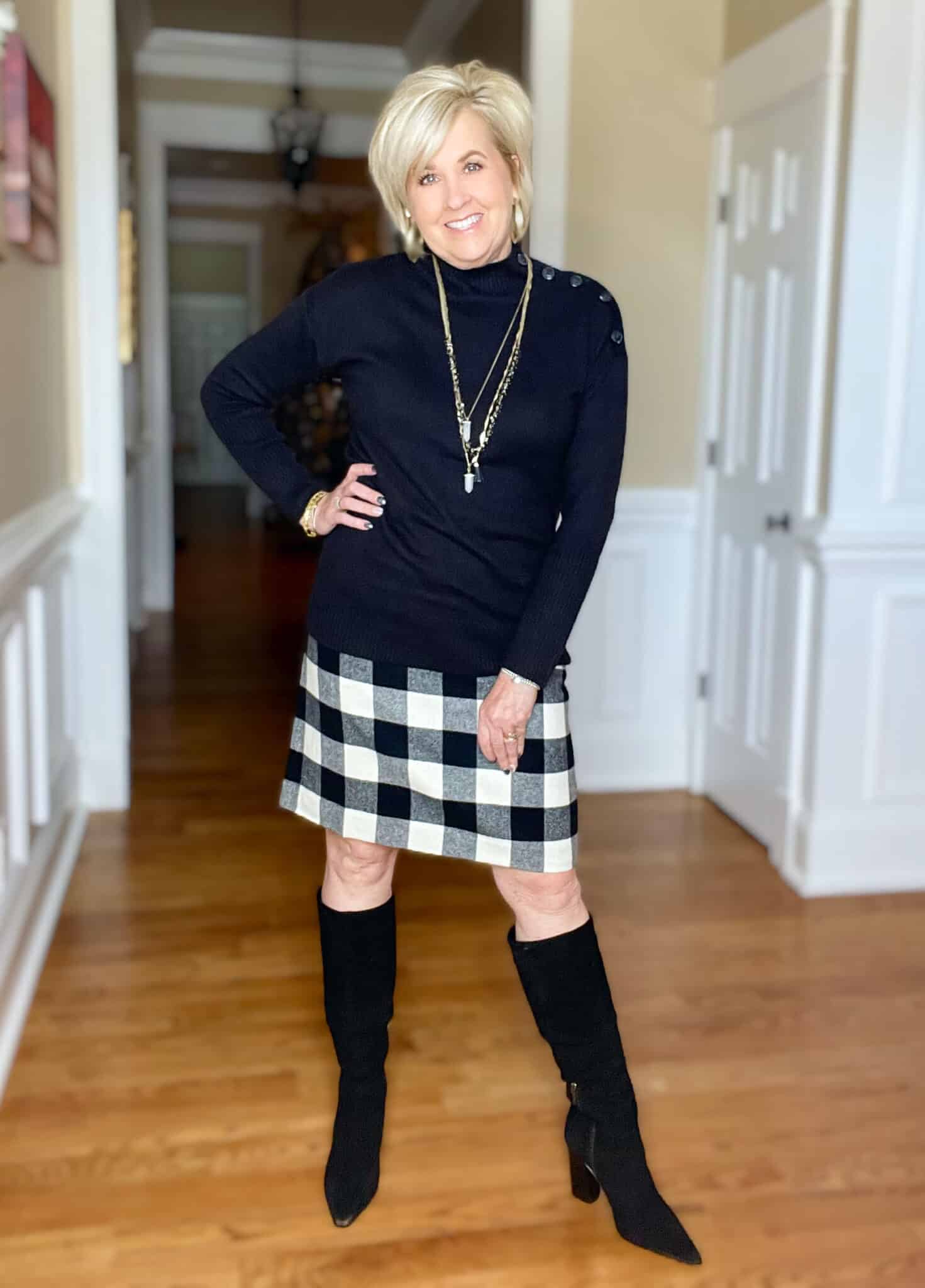 Black turtleneck sweater with buttons and buffalo plaid skirt