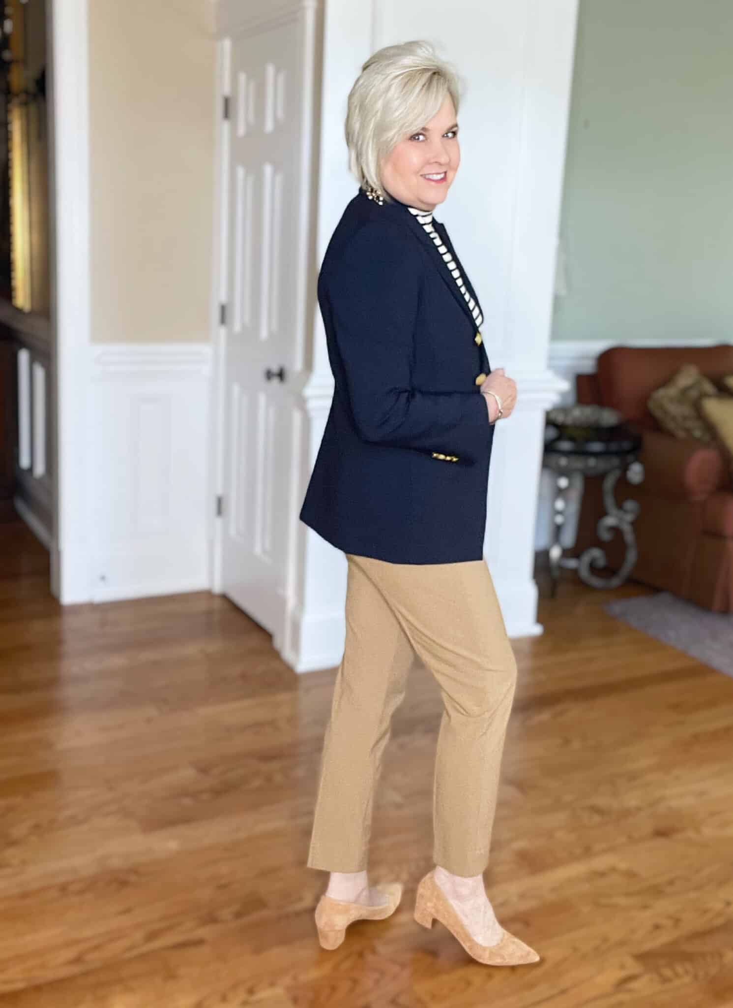 Over 40 Fashion Blogger, Tania Stephens is wearing camel pants and a navy double breasted coat