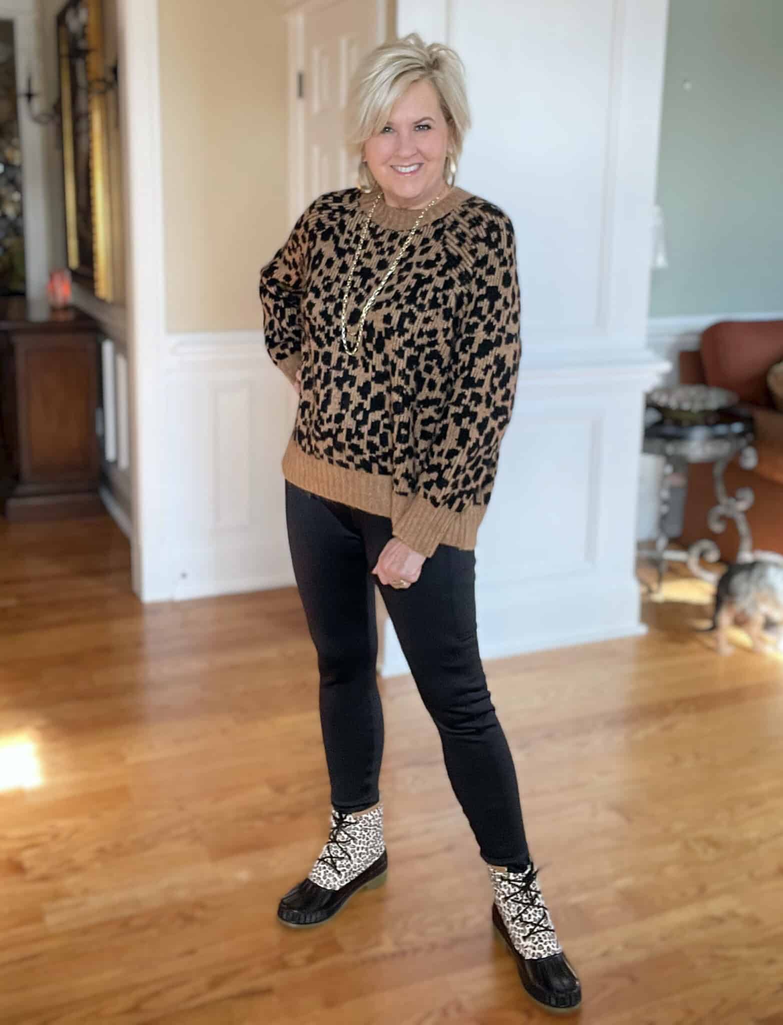 Over 40 Fashion Blogger, Tania Stephens is styling a leopard print sweater, black leggings and leopard print boots