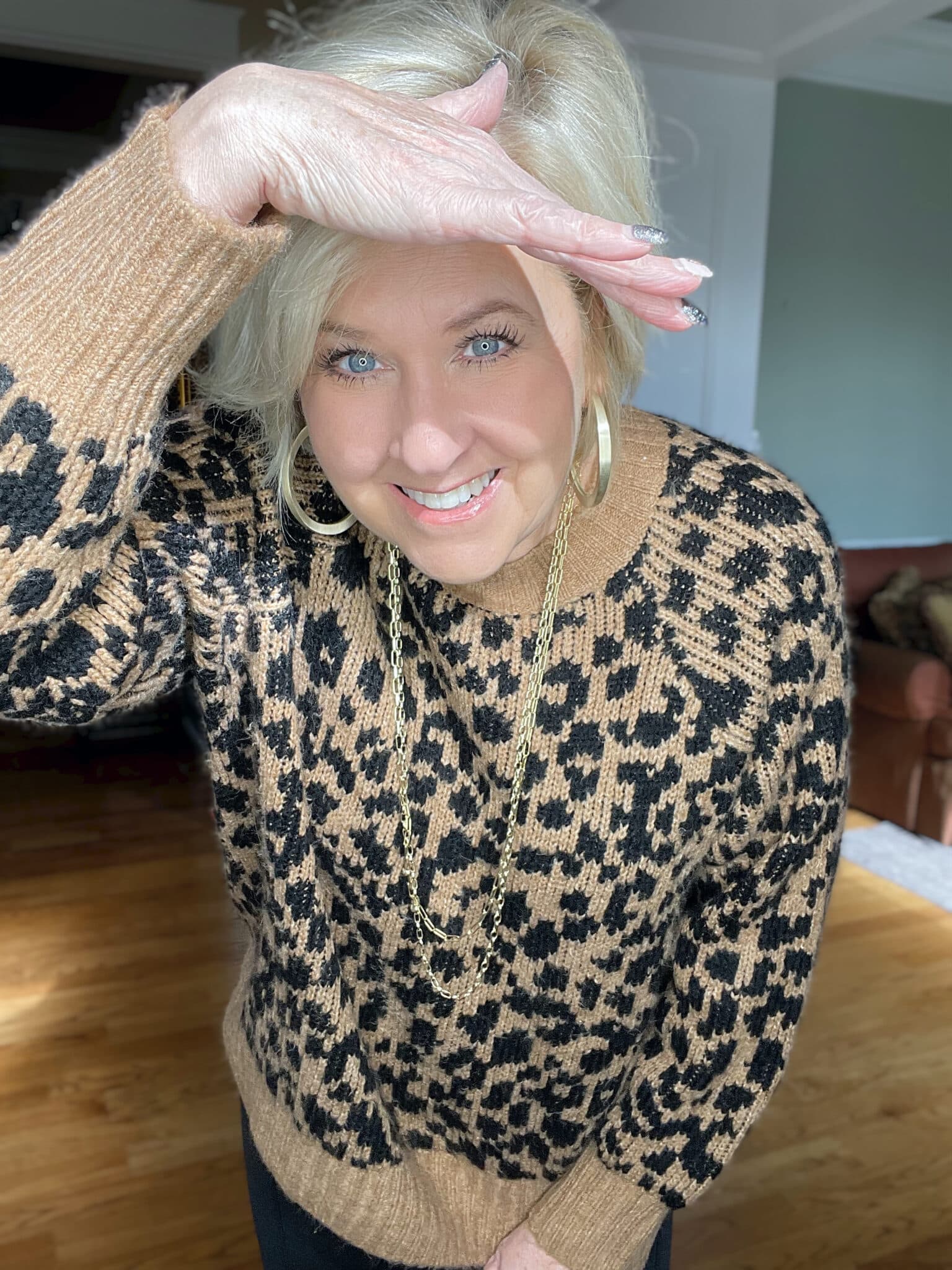 Over 40 Fashion Blogger, Tania Stephens is laughing in a leopard print sweater