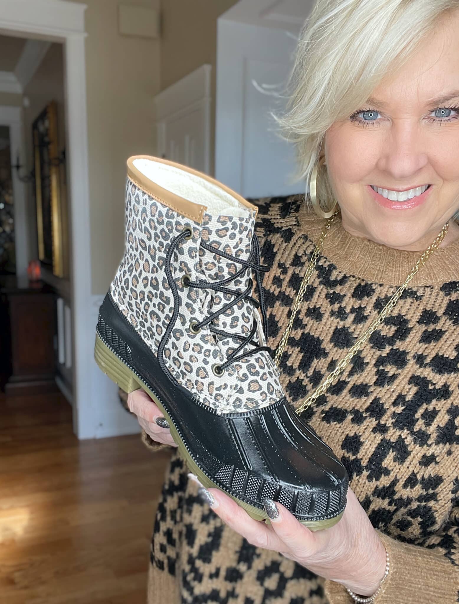 Over 40 Fashion Blogger, Tania Stephens is holding leopard print duck boots
