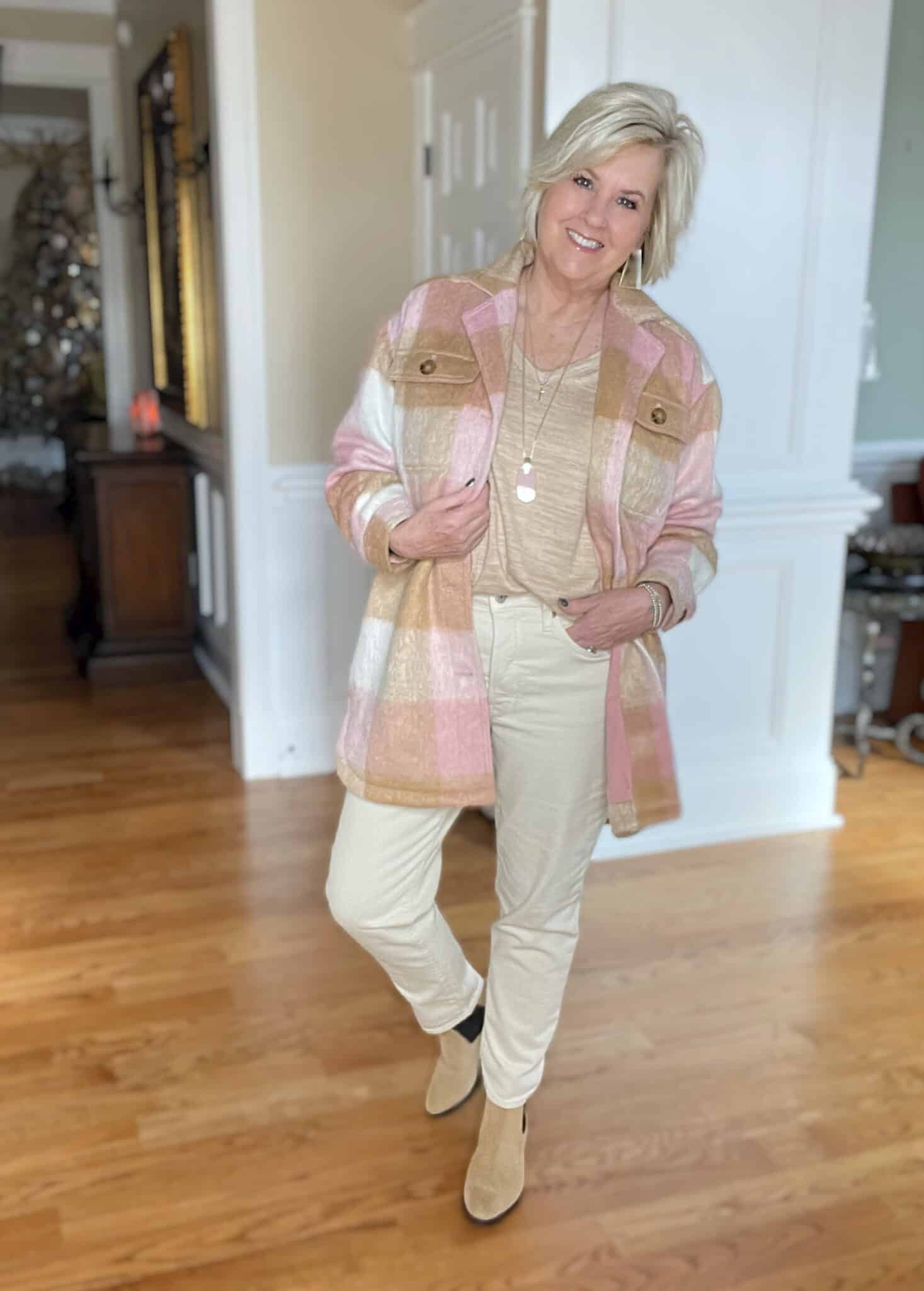 Over 40 Fashion Blogger, Tania Stephens is wearing a pink and camel shacket with a beige top with cream jeans