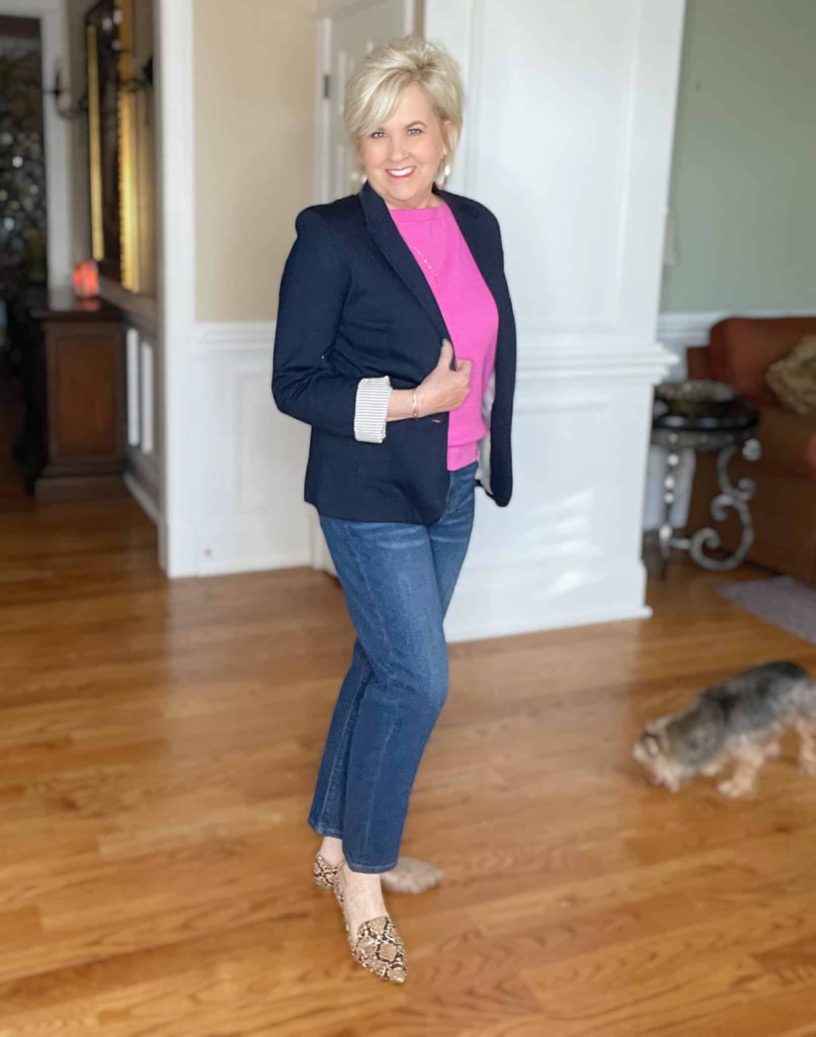 Over 40 Fashion Blogger, Tania Stephens is wearing a pin boatneck sweater, straight leg jeans, and a navy blazer