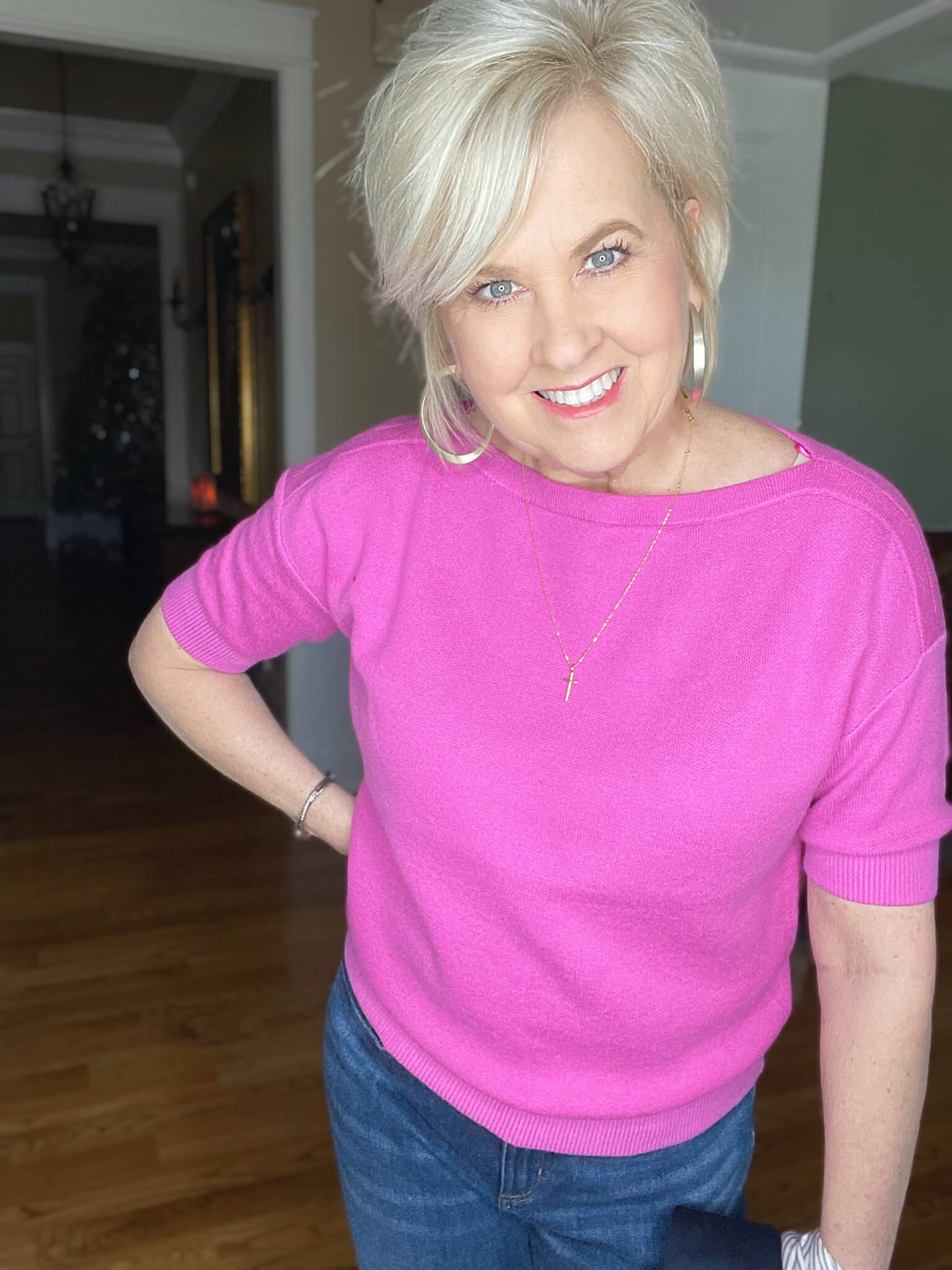 Over 40 Fashion Blogger, Tania Stephens is wearing a pin boatneck sweater and gold hoop earrings