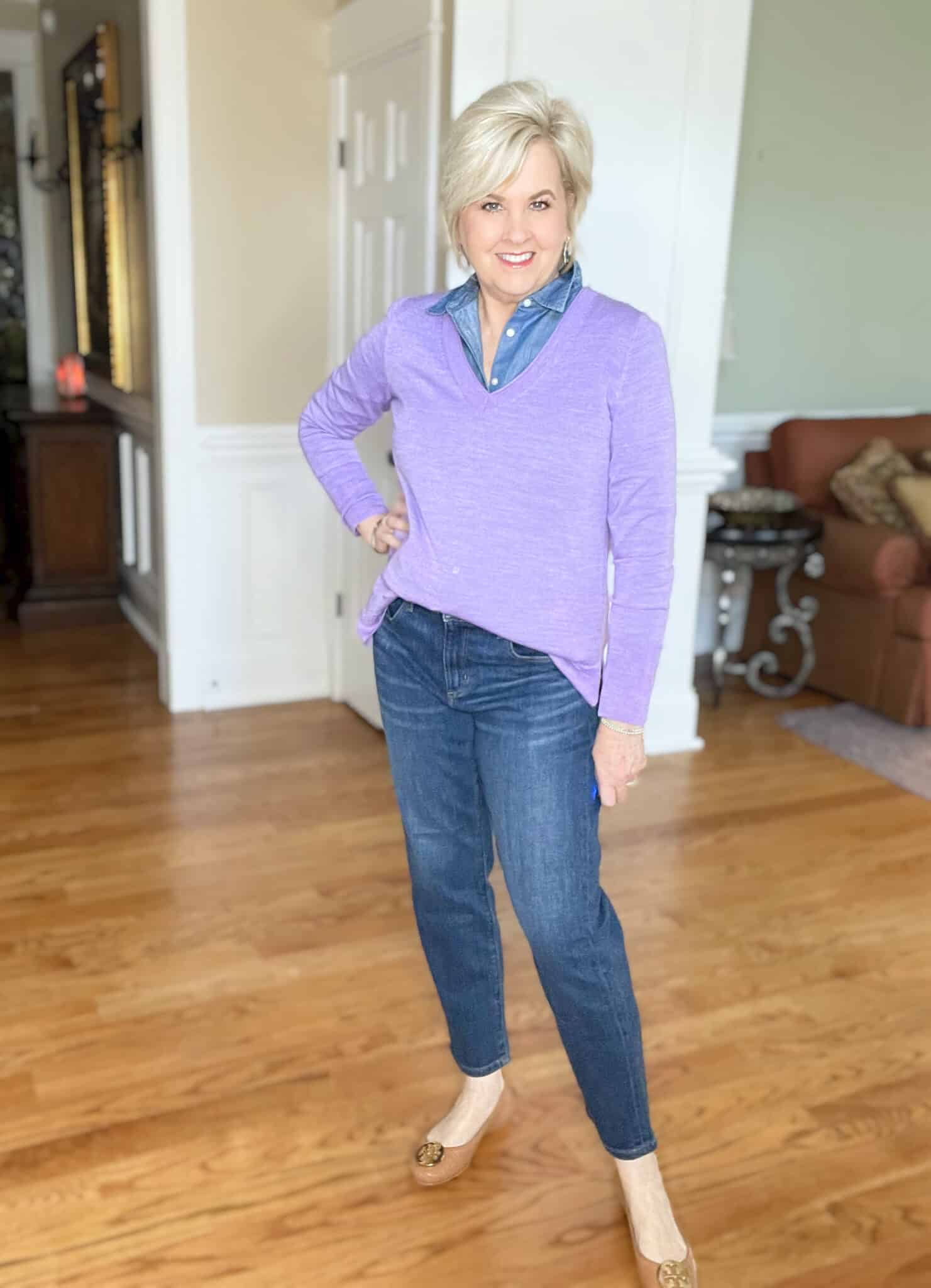 Over 40 Fashion Blogger, Tania Stephens is wearing a v-neck sweater in Very Peri with tapered jeans from Ann Taylor