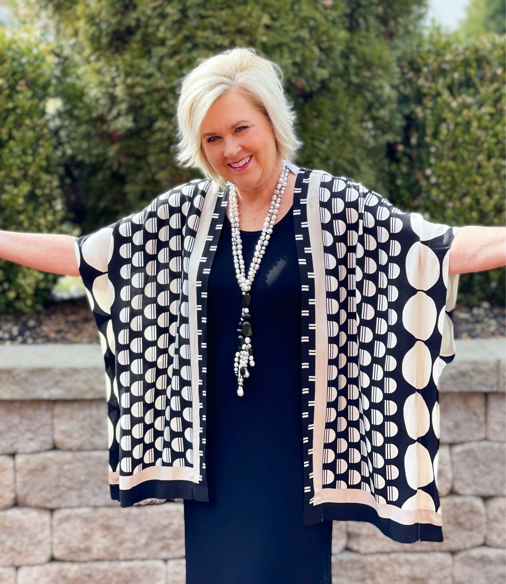 Over 40 Fashion Blogger, Tania Stephens is wearing a black and white ruana