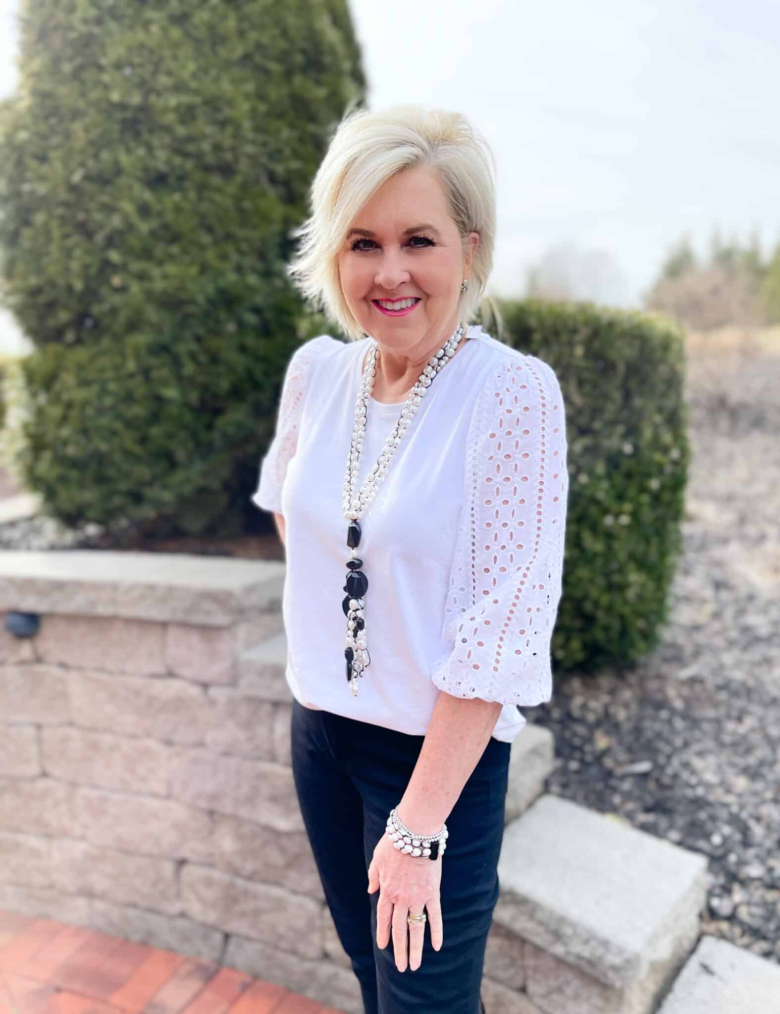 Over 40 Fashion Blogger, Tania Stephens is wearing a white eyelet top