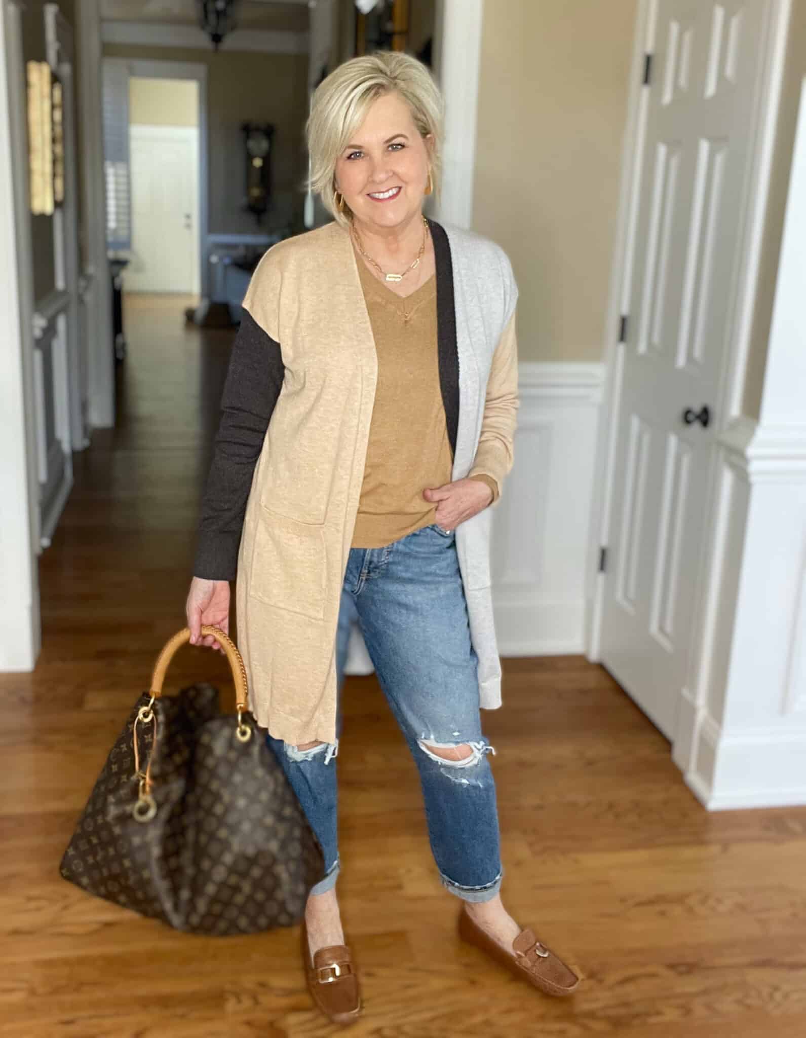 Over 40 Fashion Blogger, Tania Stephens is wearing a Hit or Miss colorblock cardigan with jeans and a Louis Vuitton handbag