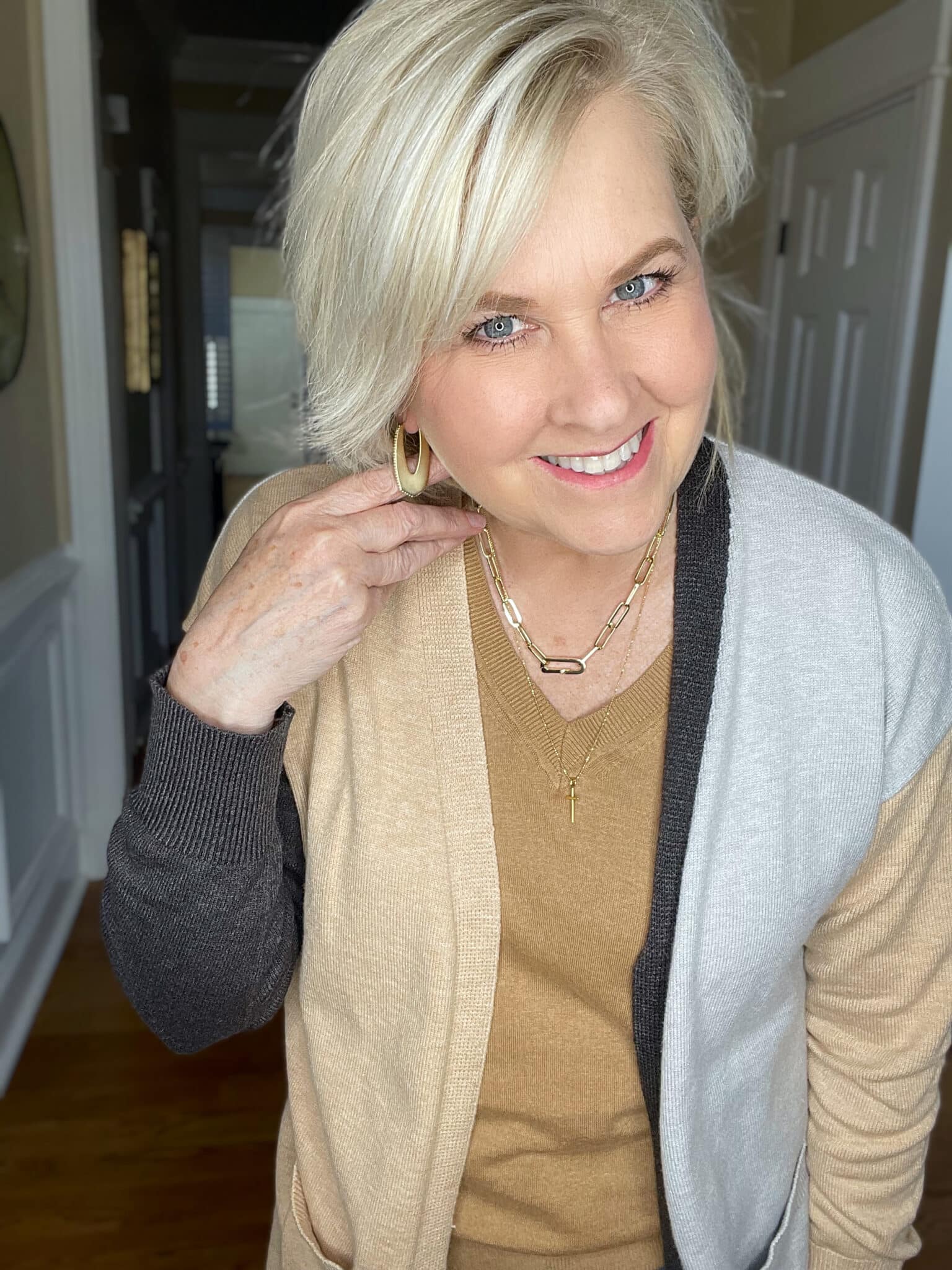 Over 40 Fashion Blogger, Tania Stephens is wearing a Hit or Miss colorblock cardigan with gold jewelry