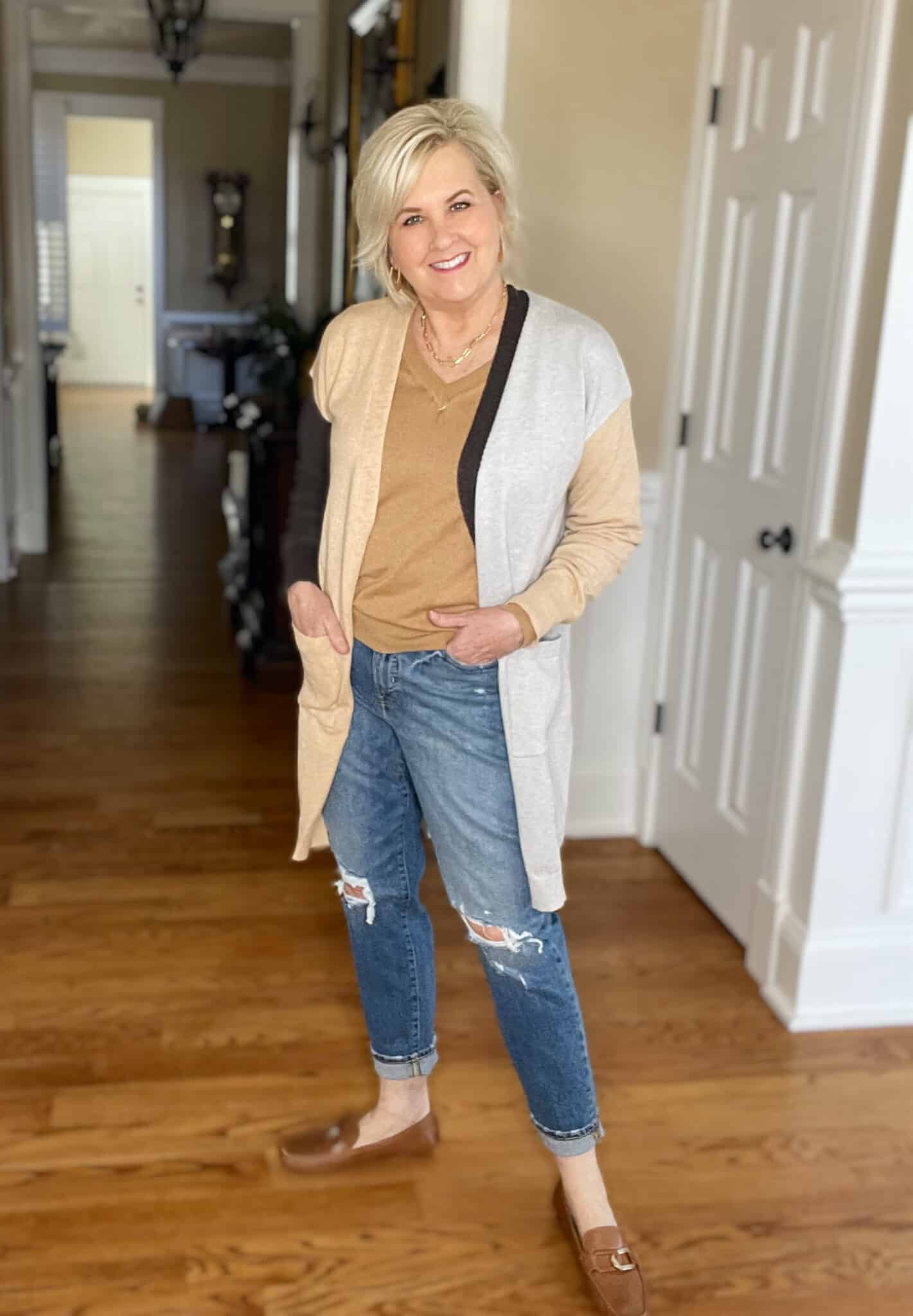 Over 40 Fashion Blogger, Tania Stephens is wearing a Hit or Miss color-block cardigan with distressed jeans and brown loafers