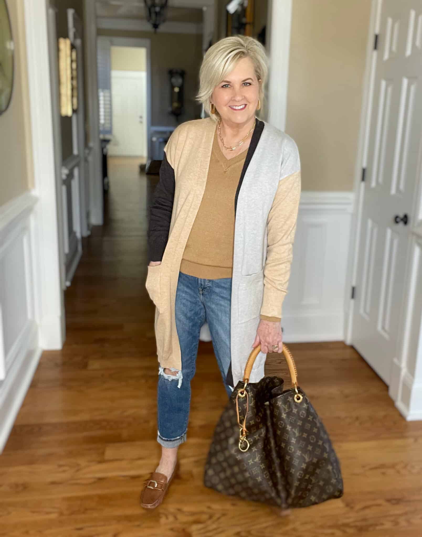 Over 40 Fashion Blogger, Tania Stephens is wearing a Hit or Miss colorblock cardigan with jeans and brown loafers