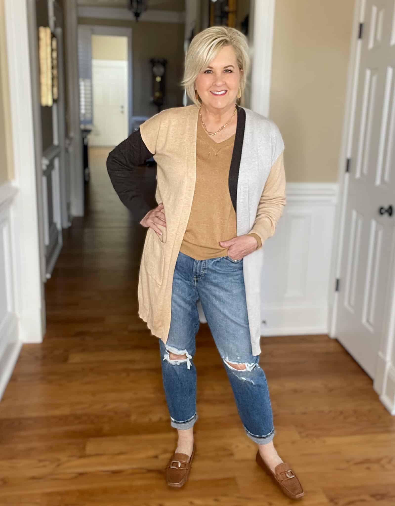 Over 40 Fashion Blogger, Tania Stephens is wearing a Hit or Miss colorblock cardigan with distressed jeans and brown loafers