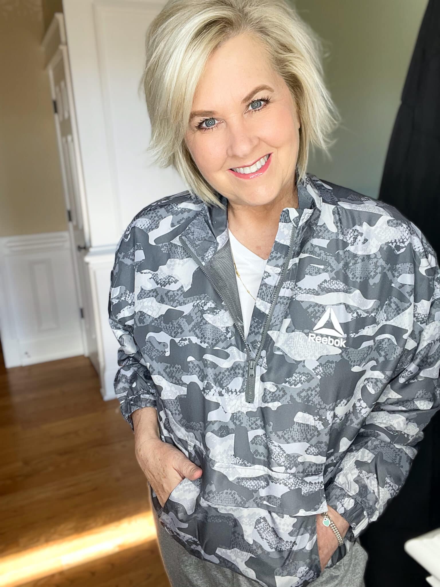 Over 40 Fashion Blogger, Tania Stephens is wearing a gray camo windbreaker