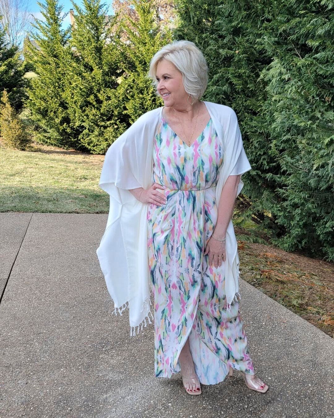 Over 40 Fashion Blogger, Tania Stephens is looking romantic in this multi-color dress and white wrap with nude heels