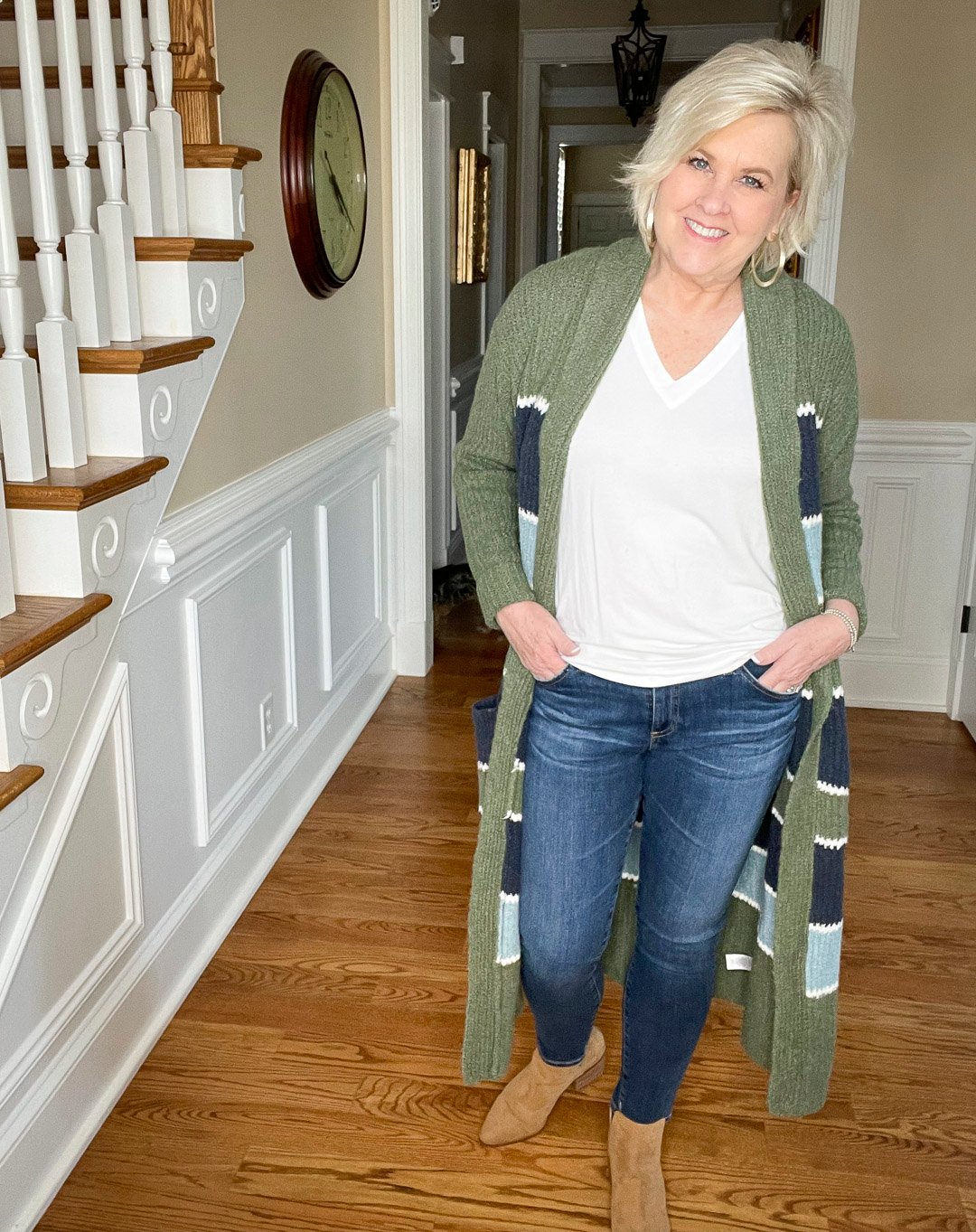 Over 40 Fashion Blogger, Tania Stephens is wearing a white t-shirt and skinny jeans with a striped cardigan