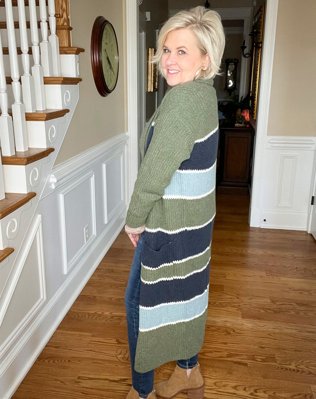 Over 40 Fashion Blogger, Tania Stephens is wearing skinny jeans with a striped cardigan and ankle boots