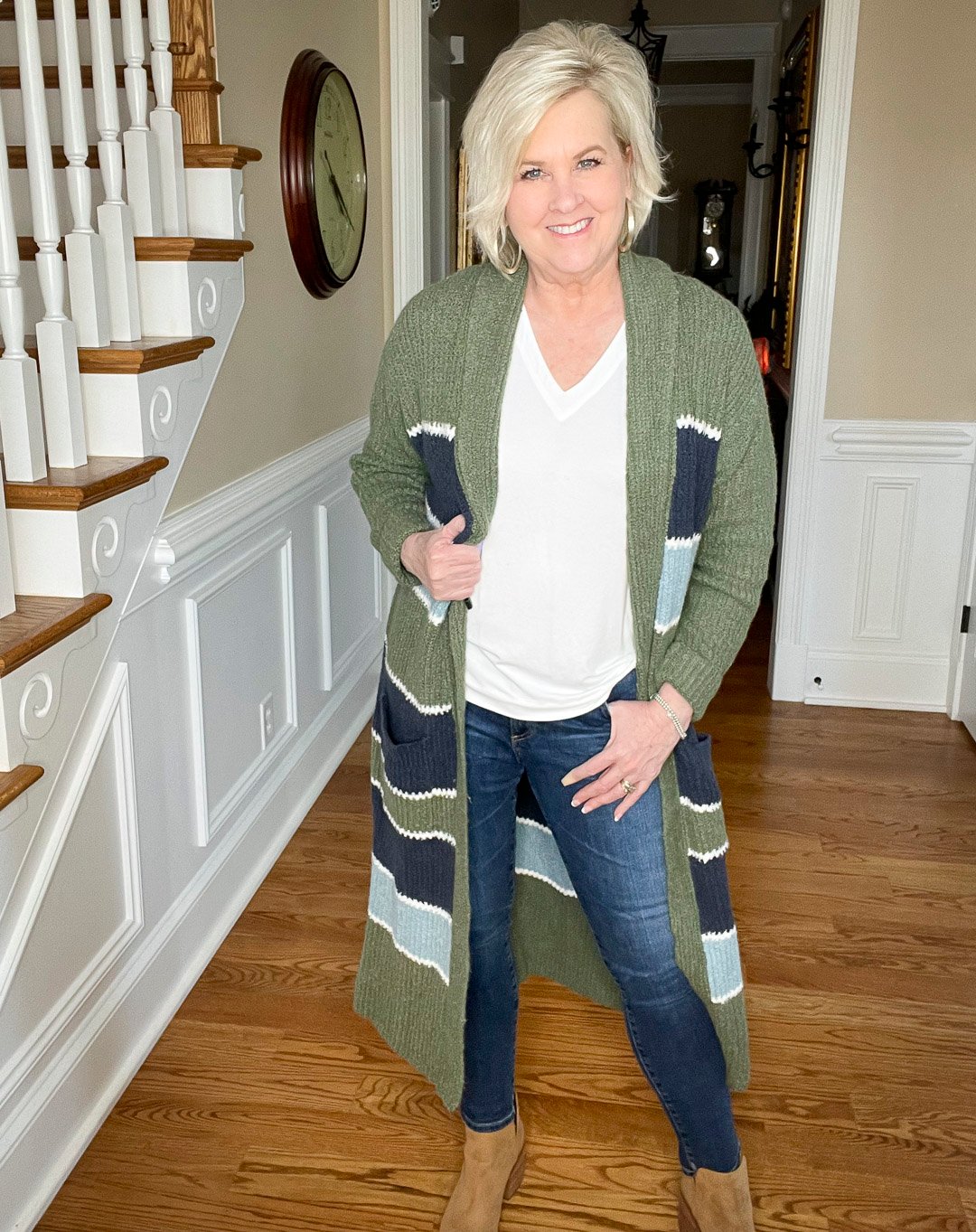 Over 40 Fashion Blogger, Tania Stephens is wearing a white t-shirt and skinny jeans with a striped duster and ankle boots