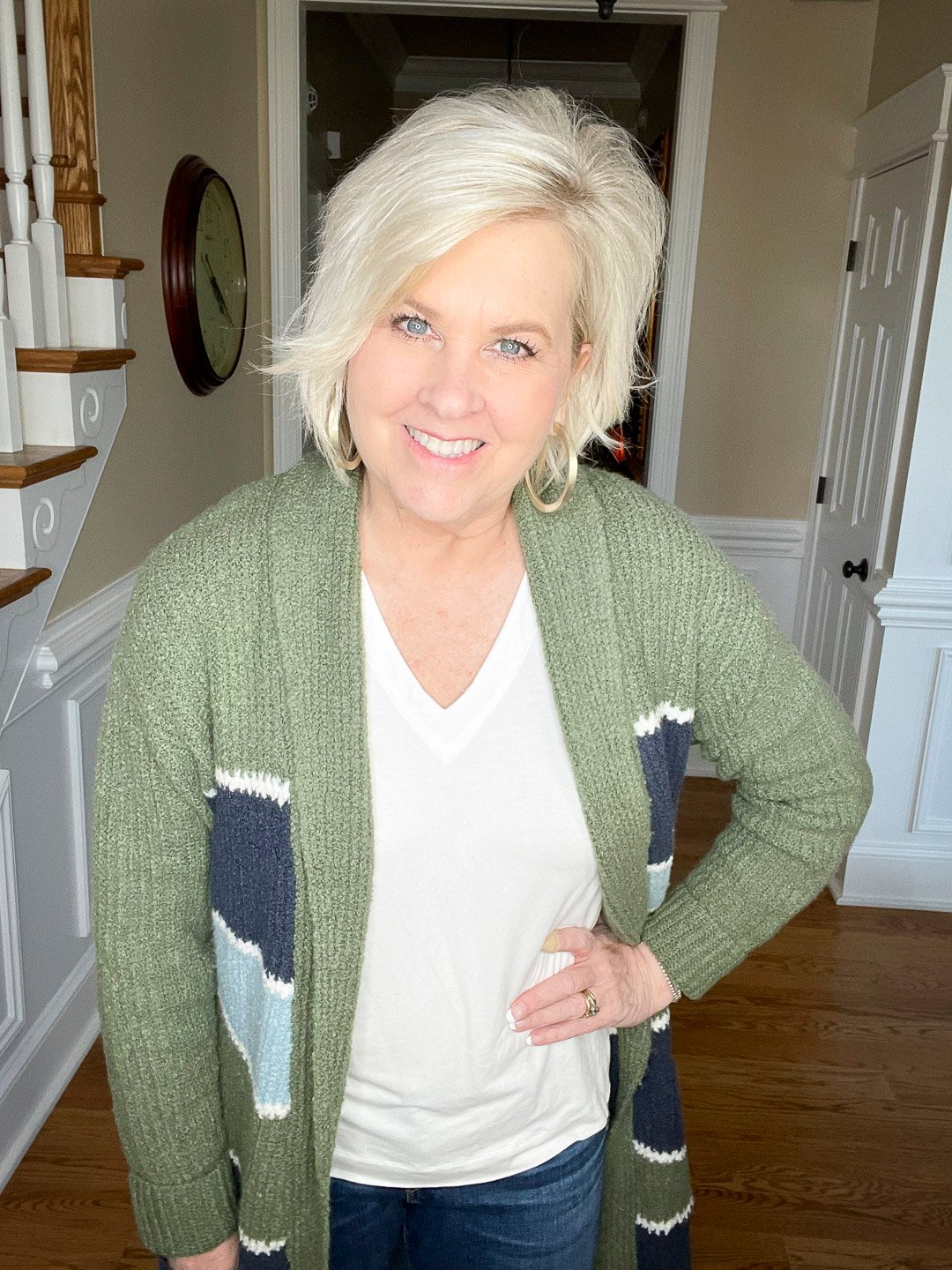 Over 40 Fashion Blogger, Tania Stephens is wearing a white t-shirt with a striped cardigan