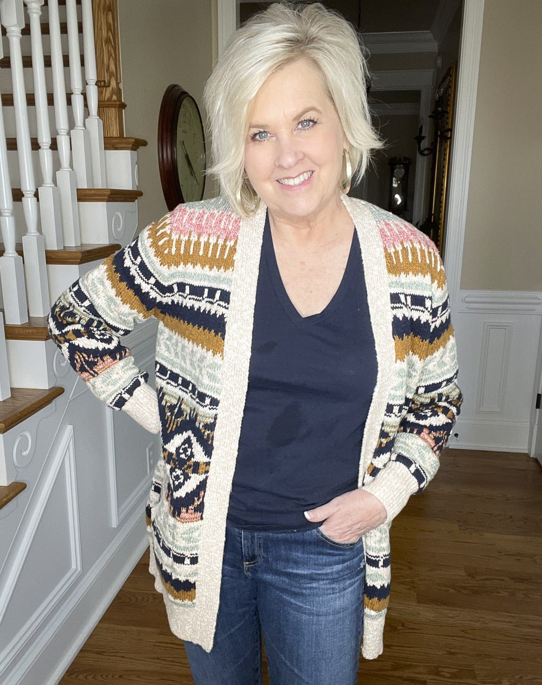 Over 40 Fashion Blogger, Tania Stephens is wearing a navy t-shirt and a multi-colored striped cardigan
