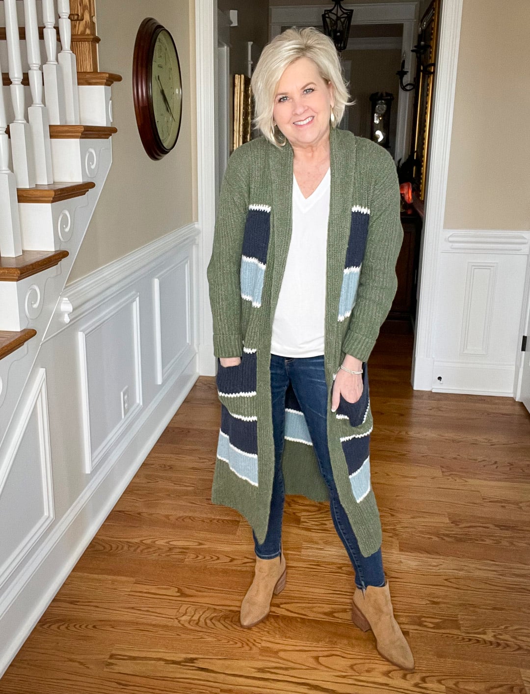 Over 40 Fashion Blogger, Tania Stephens is wearing a white t-shirt and skinny jeans with a striped cardigan and ankle boots from Nordstrom
