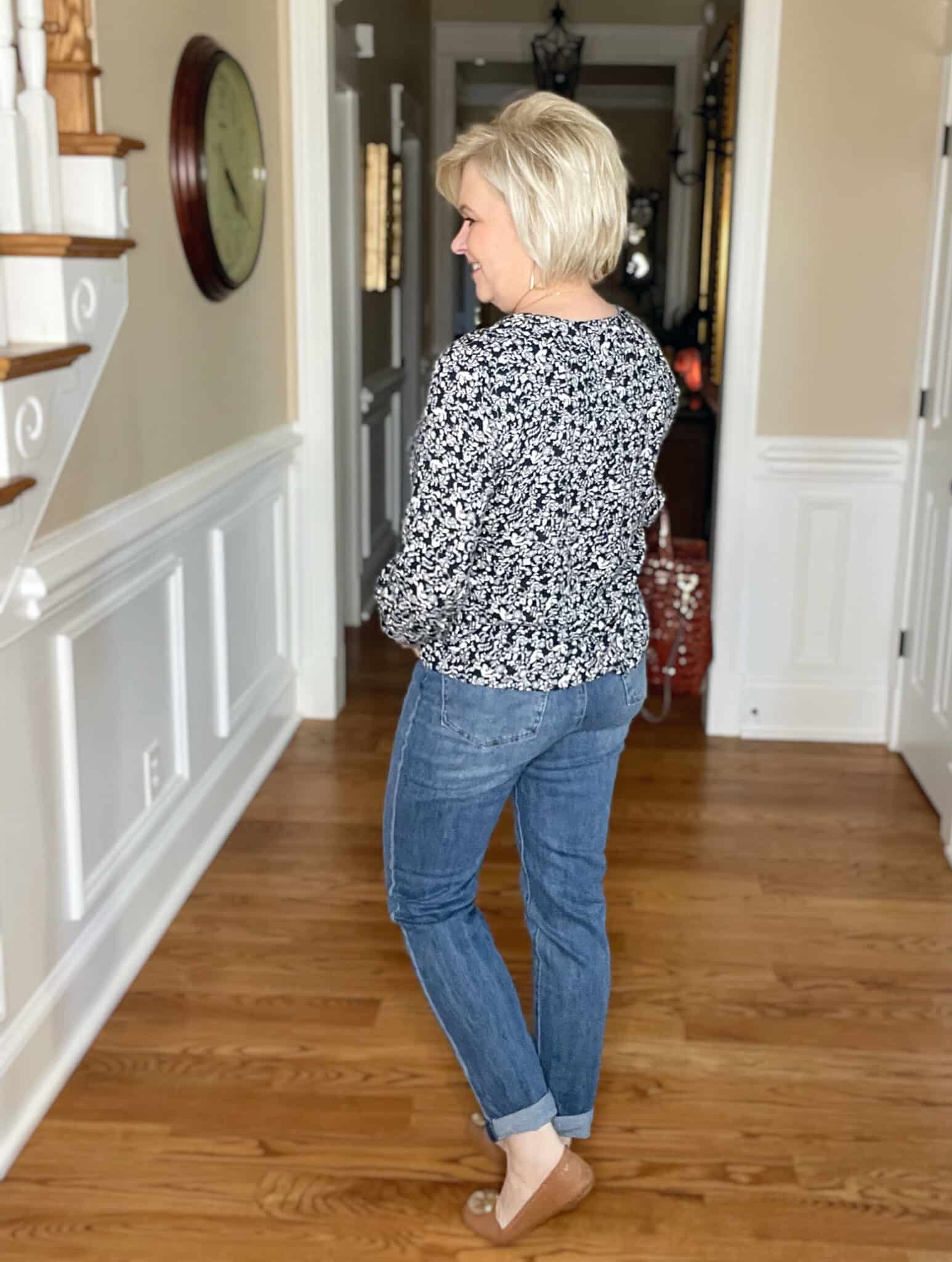 Over 40 Fashion Blogger, Tania Stephens is showing the back of a navy and white floral top and a pair of jeans